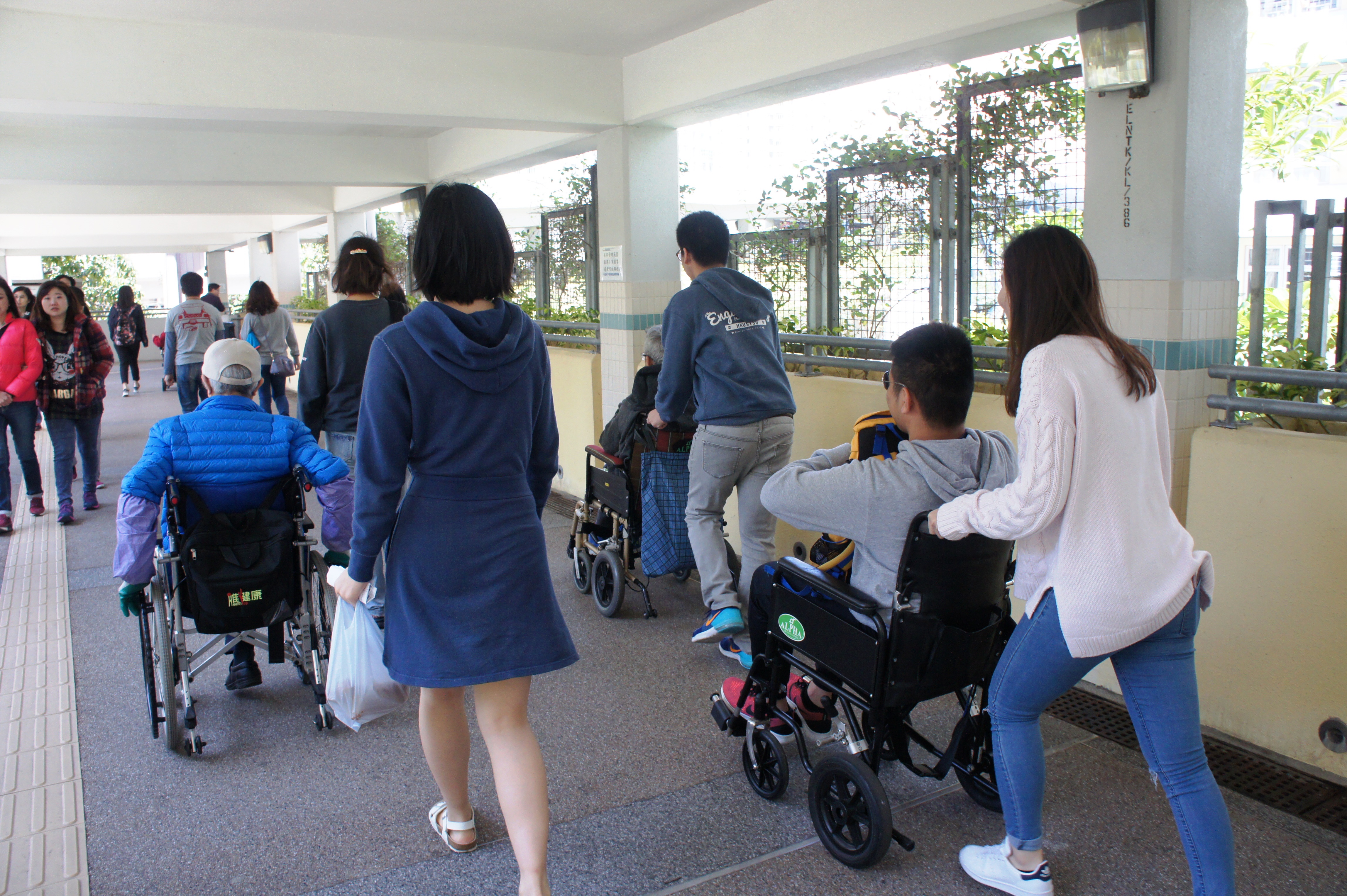 Volunteers experiencing the accessibility facilities with disabled people