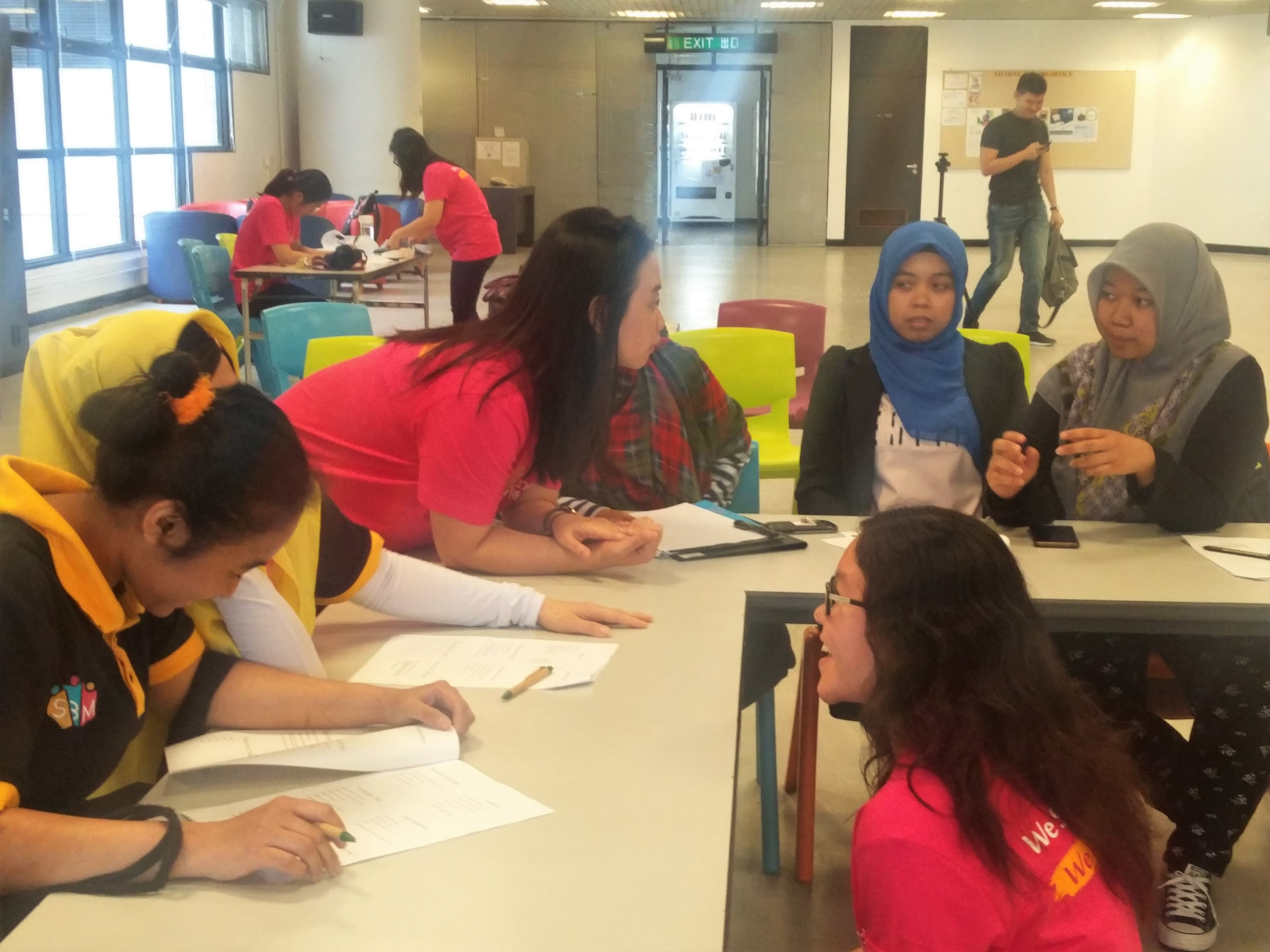 Volunteers teaching the workers some business skills