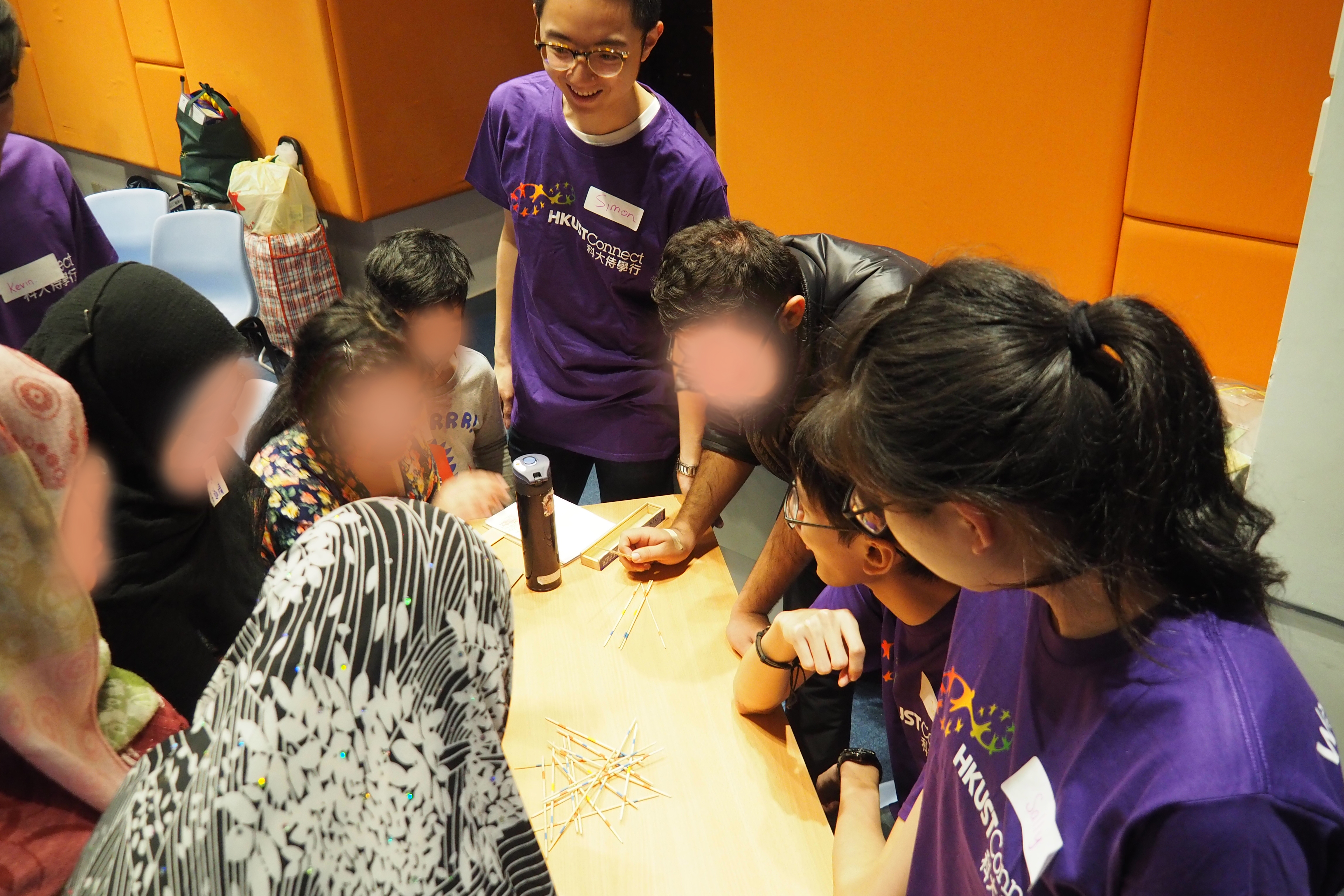 Volunteers introducing a Hong Kong game to recipients