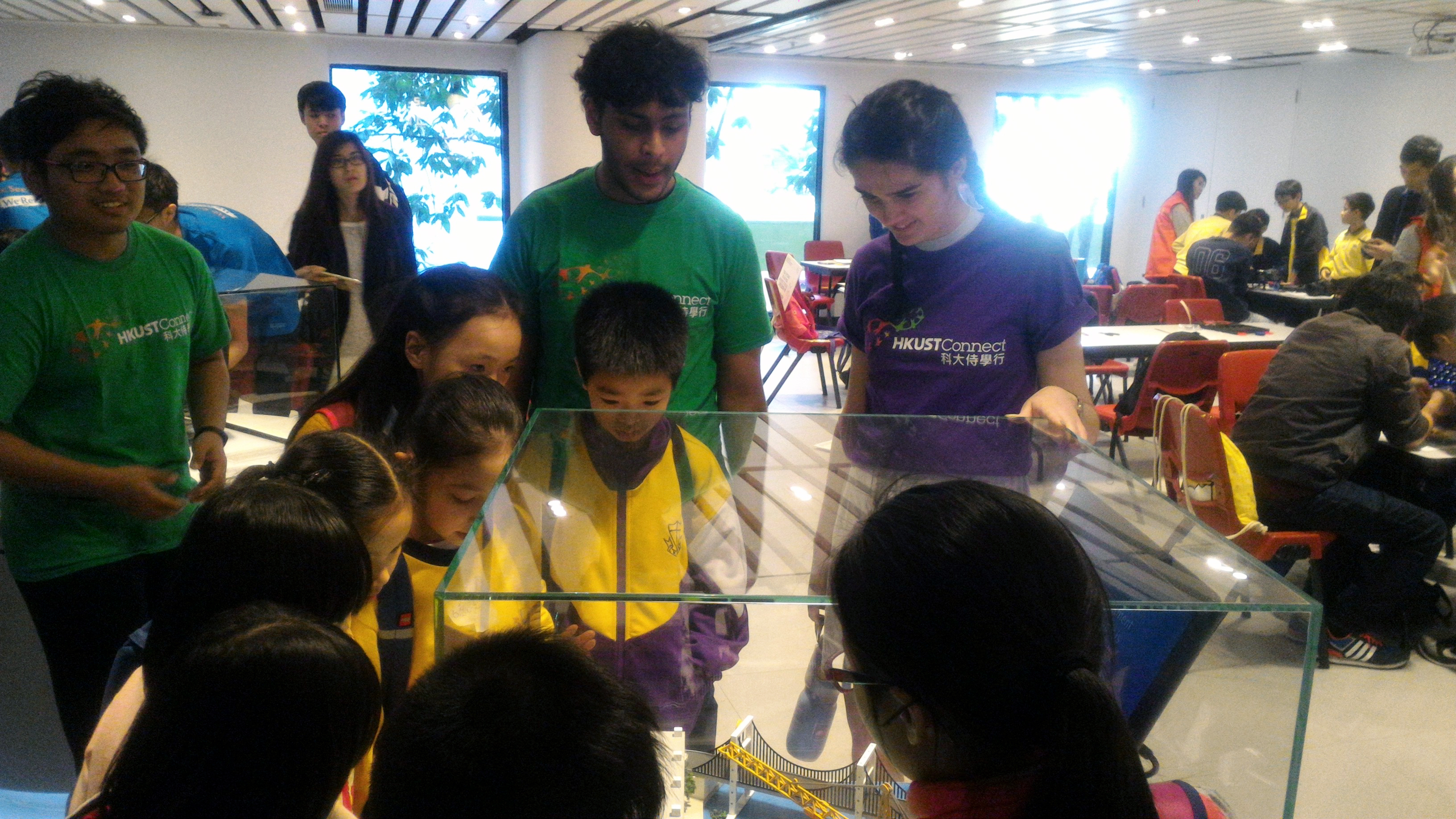 Children fascinated by the engineering model displayed on campus