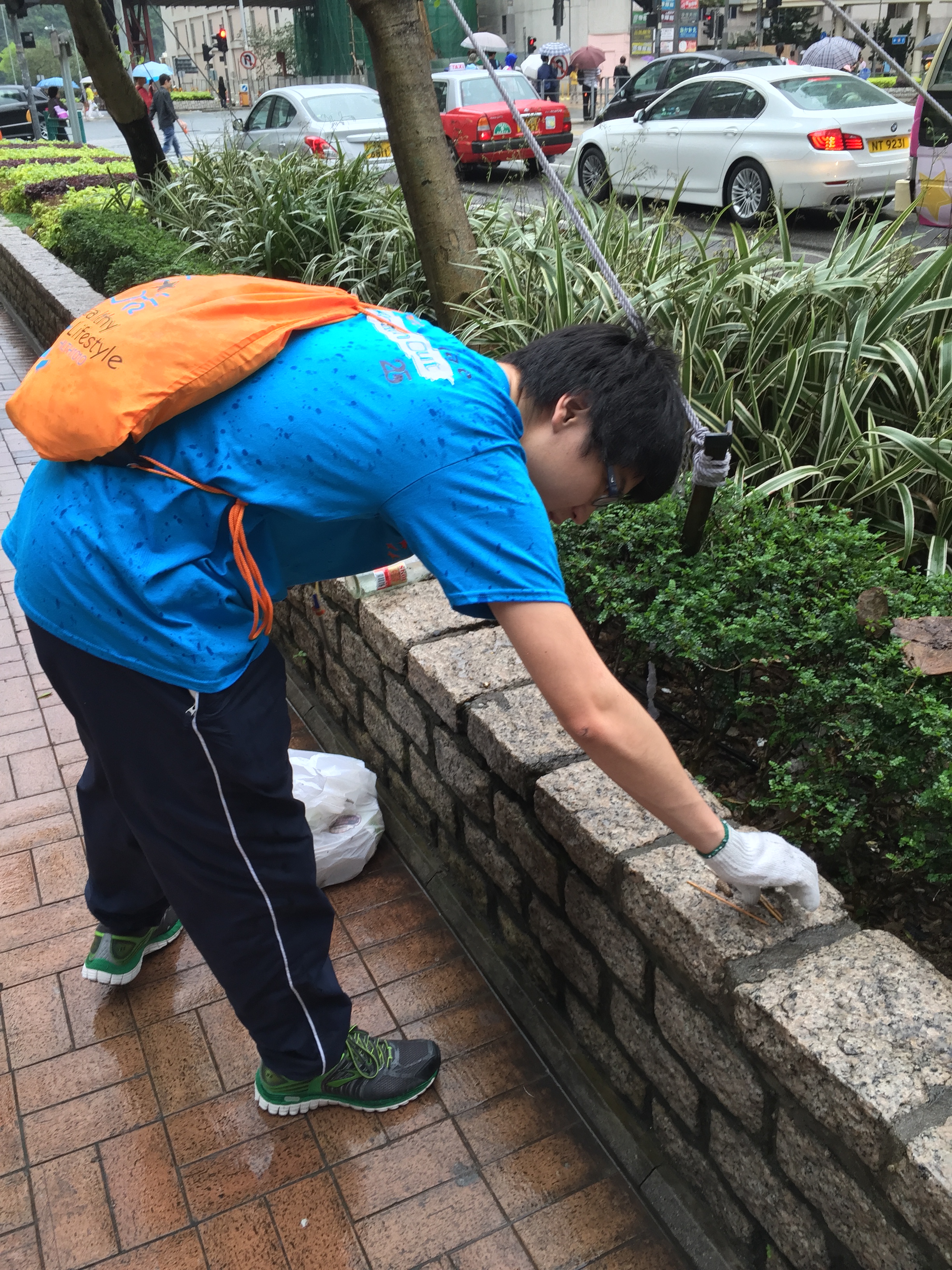 Volunteer picking up trash on the street