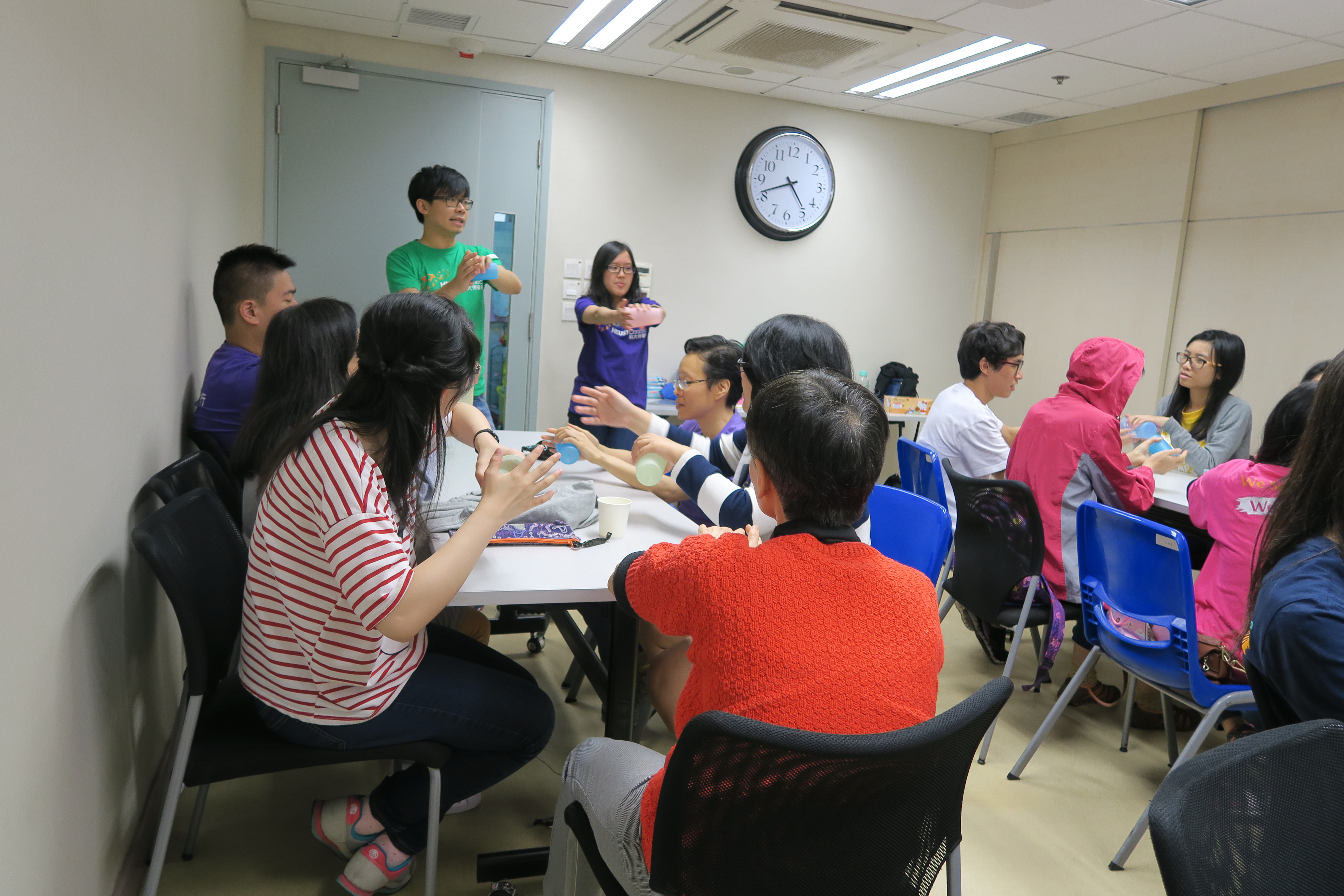 Volunteers teaching the visually impaired people of hand exercise