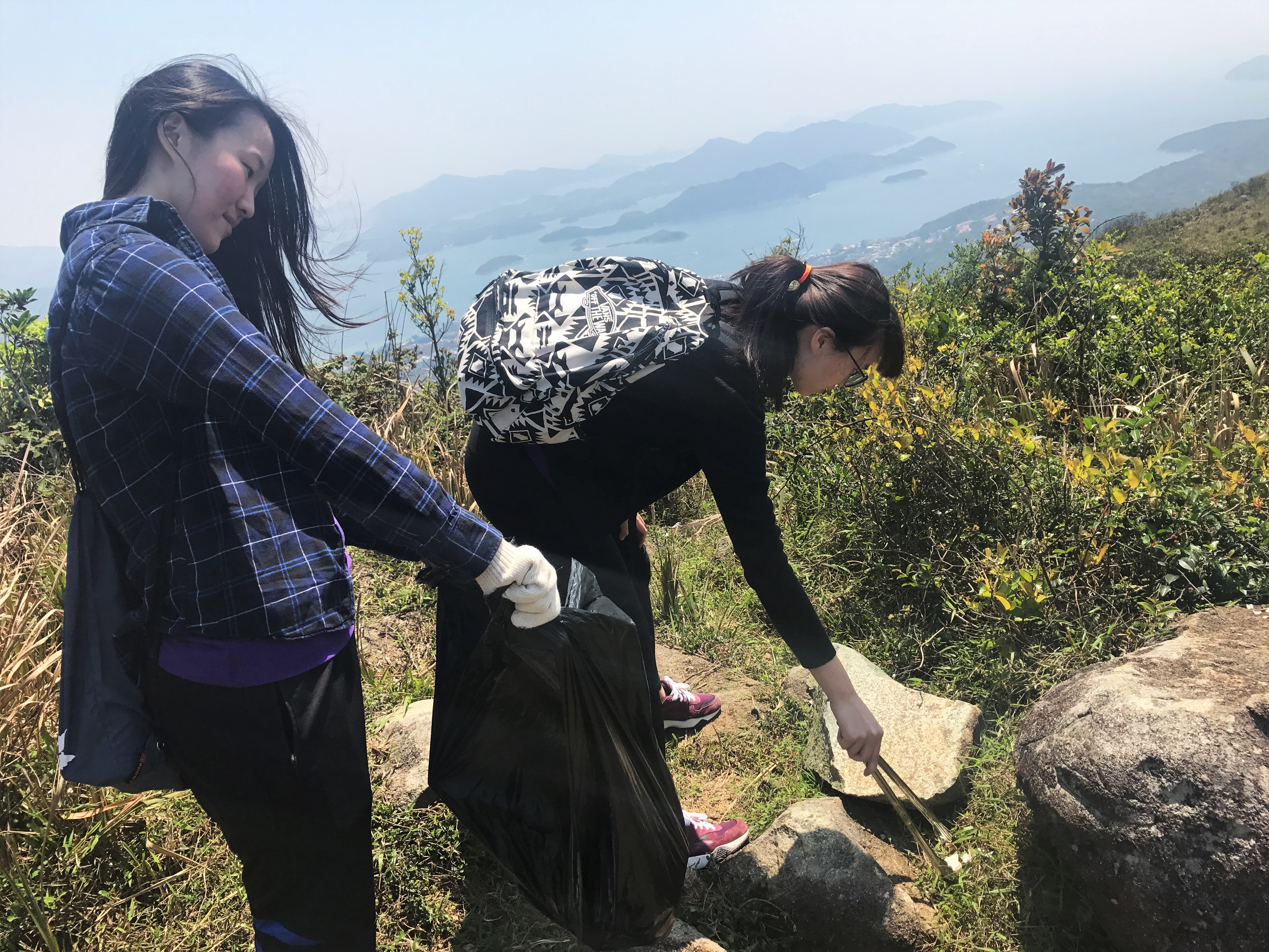 Volunteers picking up trash left by other hikers to keep the trail clean for everyone