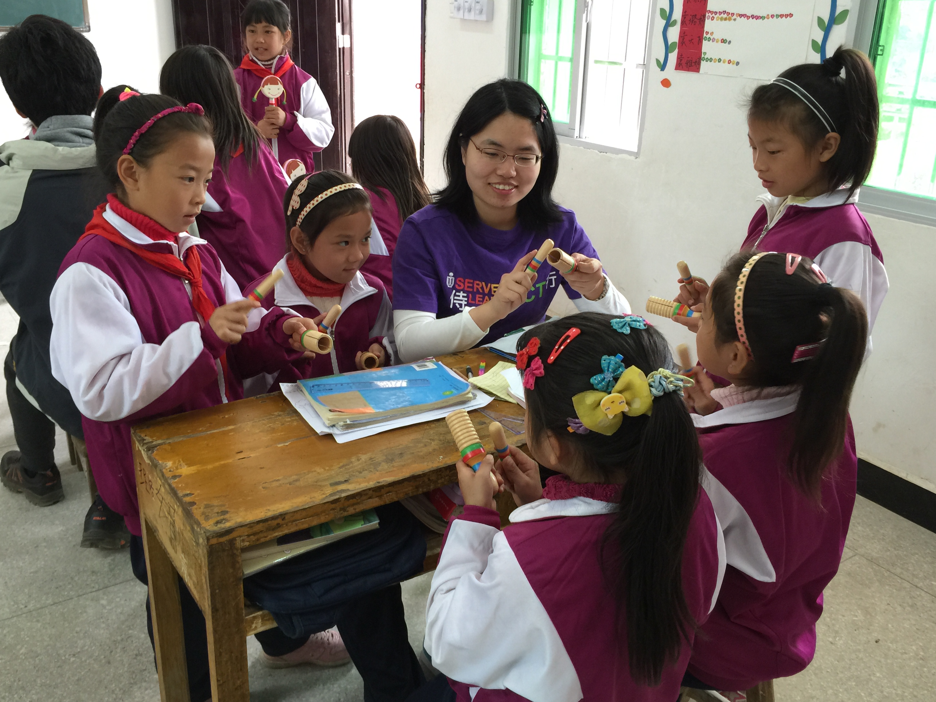 Volunteer playing music with children