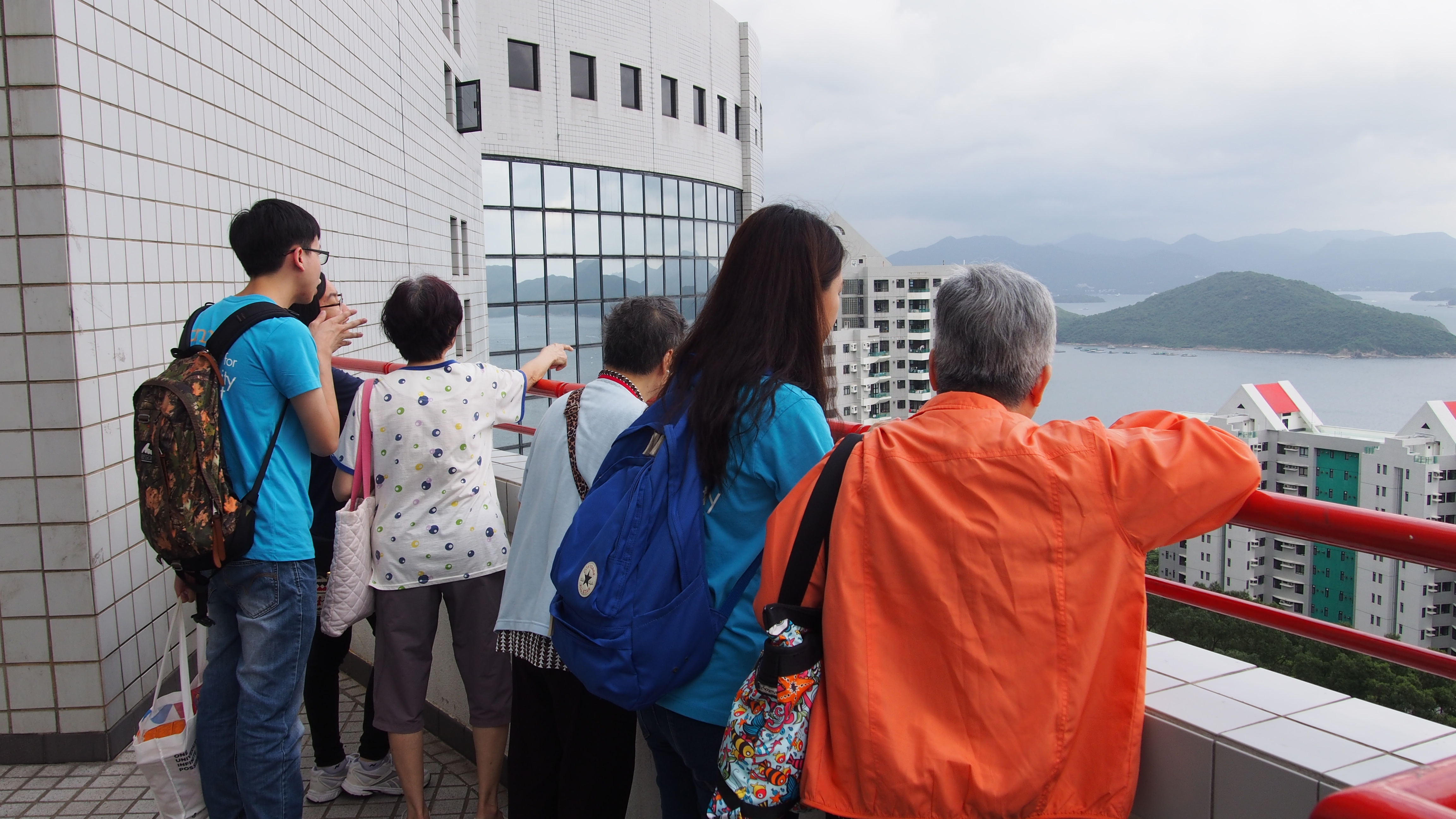 Volunteers and the elderly admiring the view of HKUST Campus