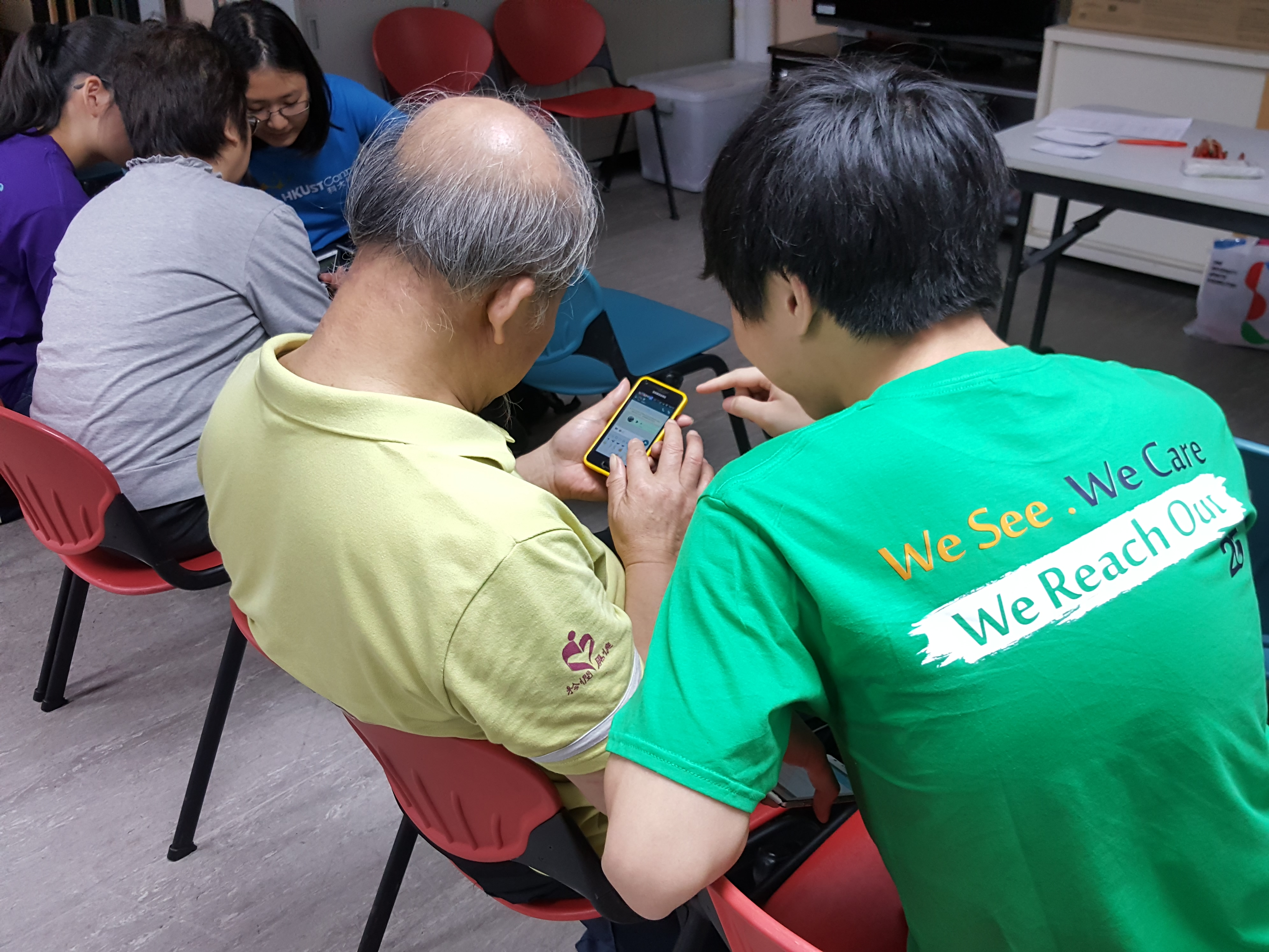 An elder trying to use a smart phone