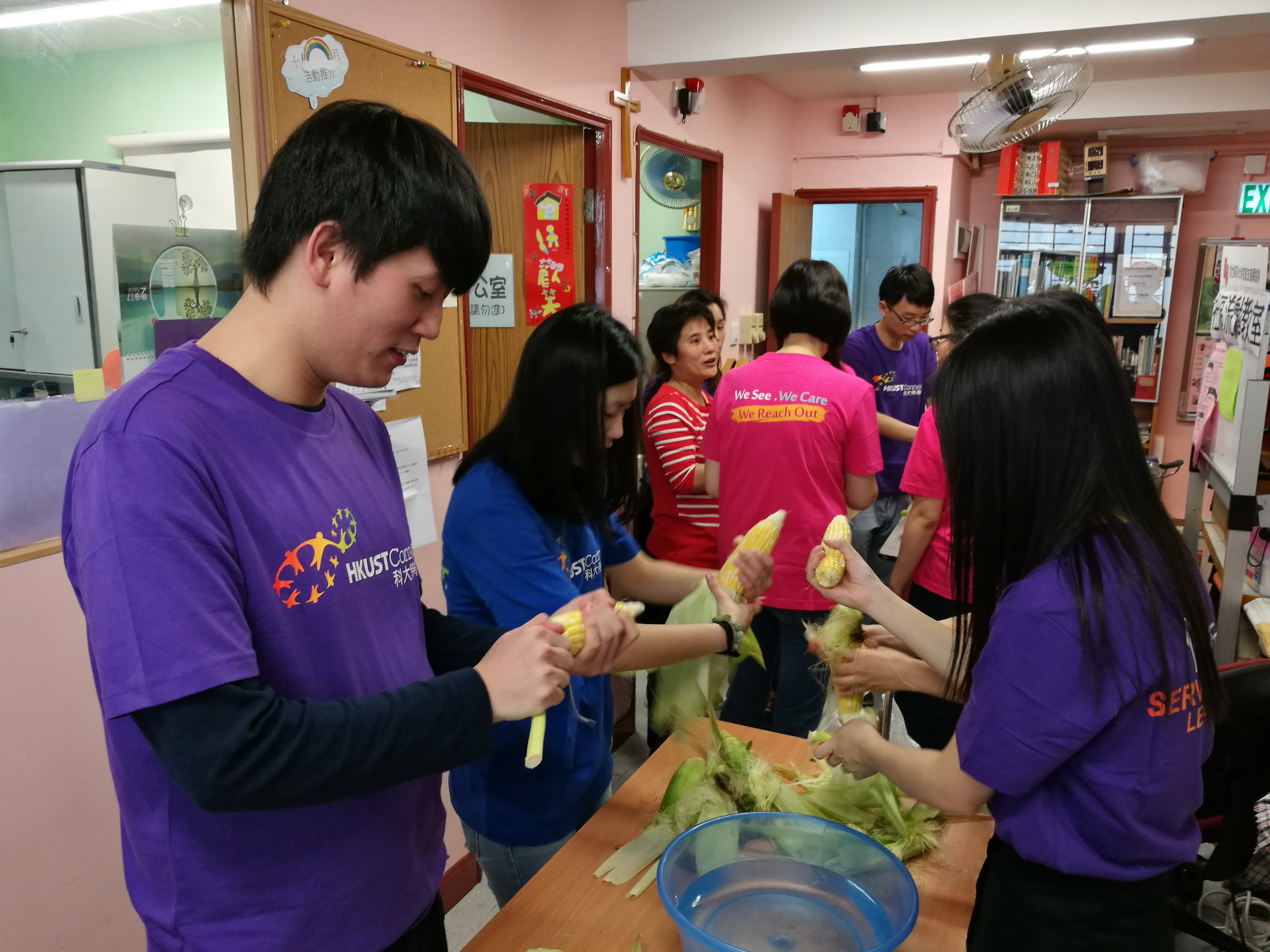Volunteers peeling the corn for the soup