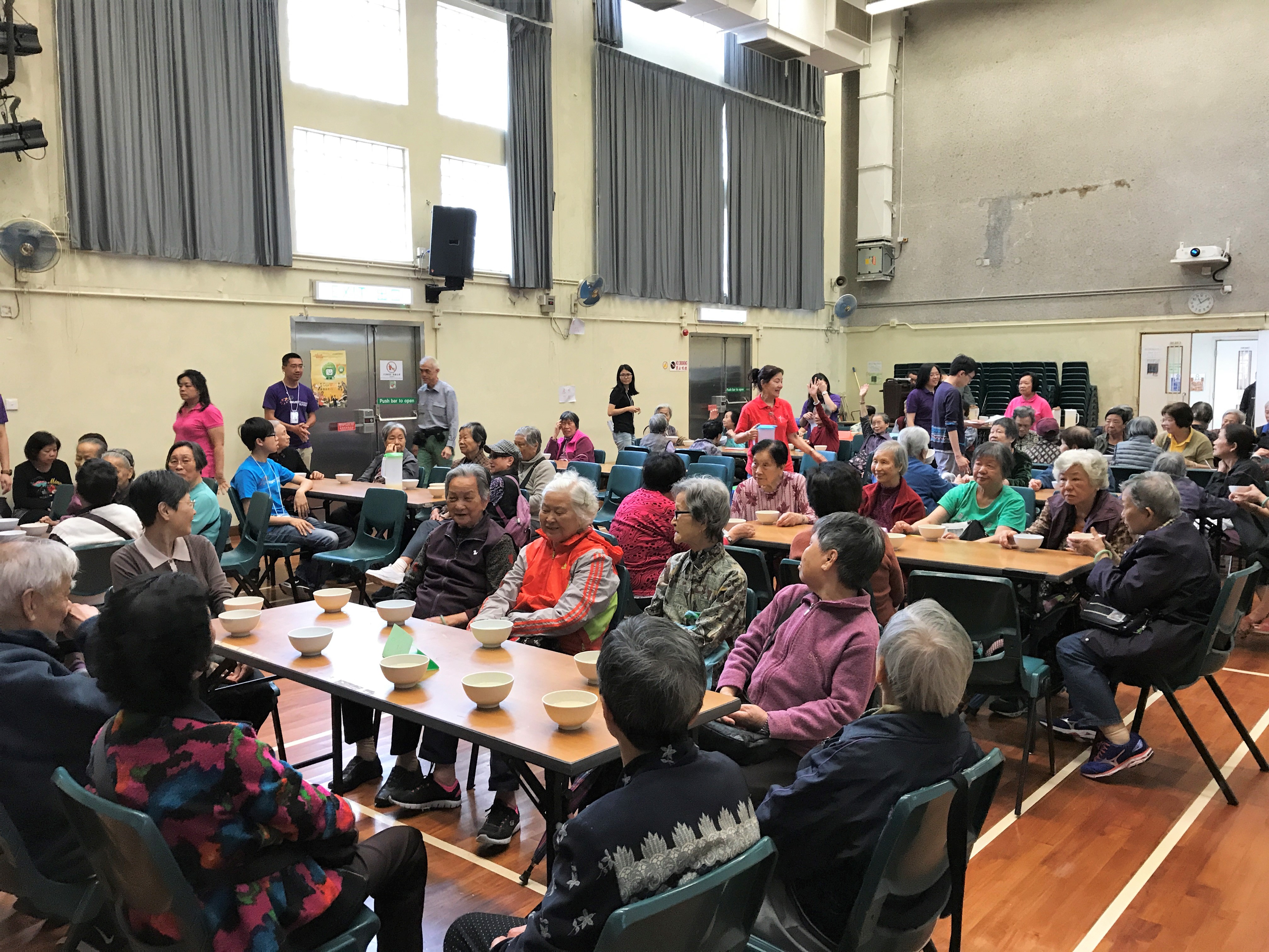 Elderly gathering in the hall to have soup and chat together