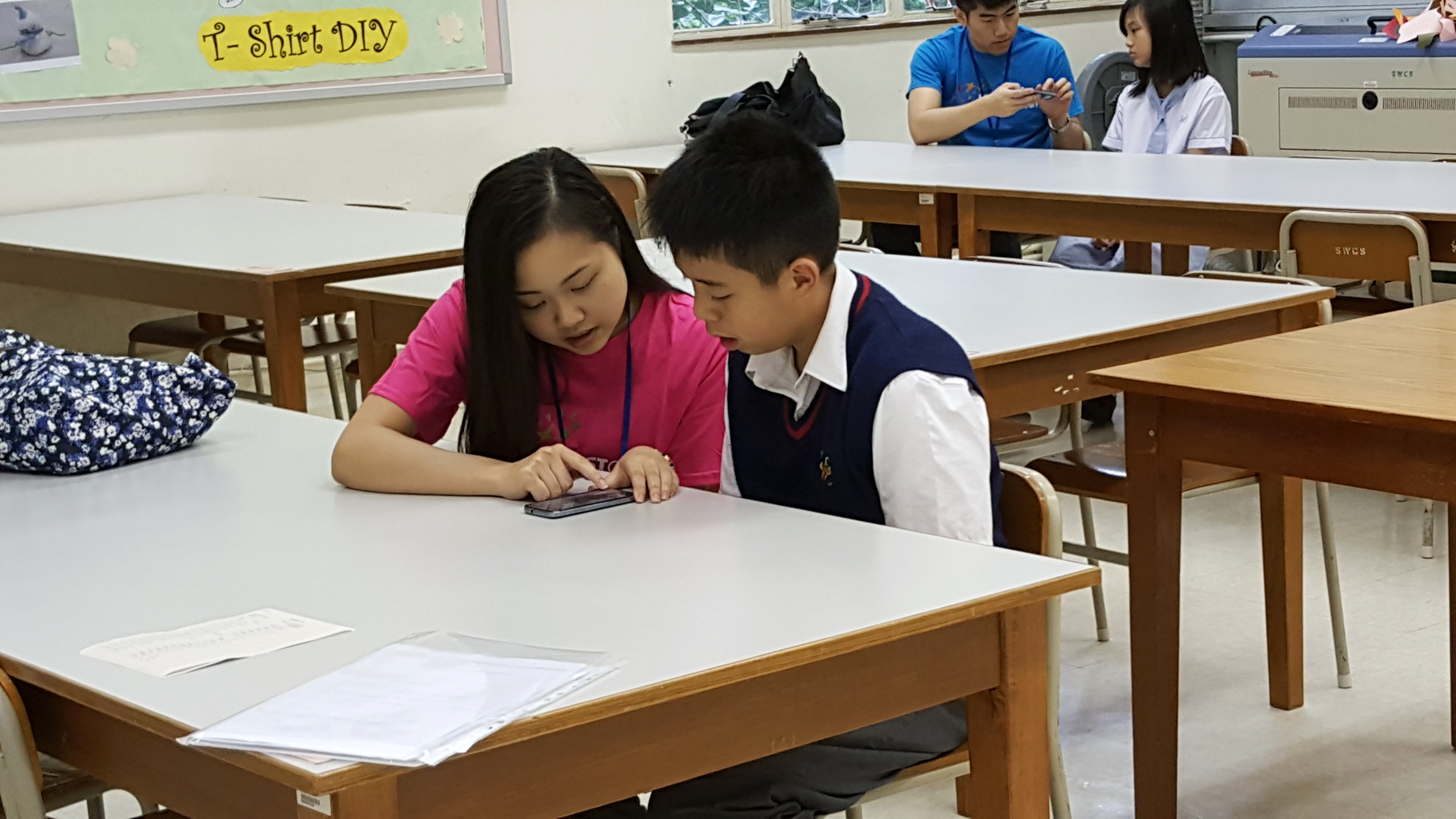 Volunteer collecting voice sample from secondary school student