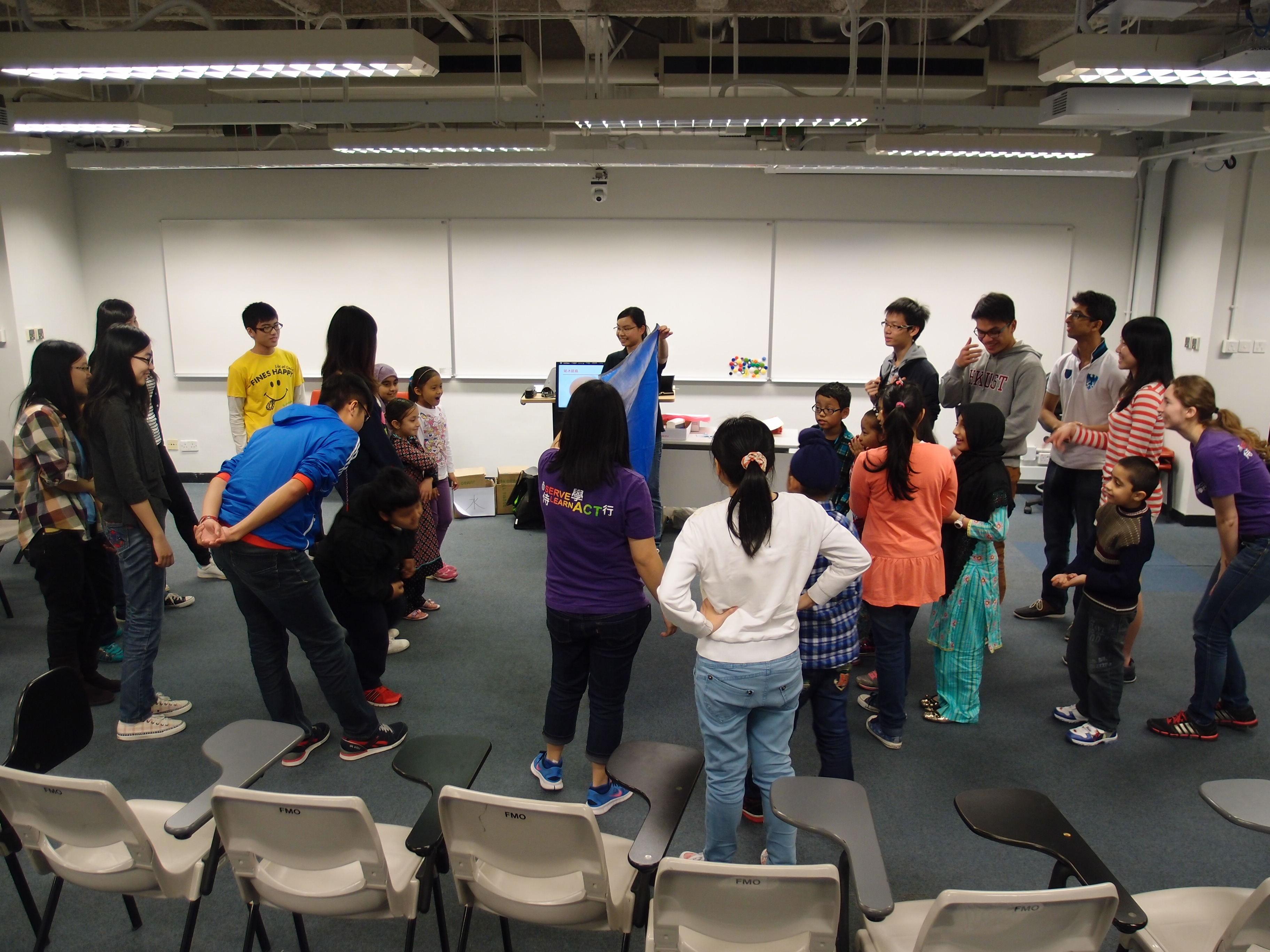 Children following the body movement of the volunteers in a game