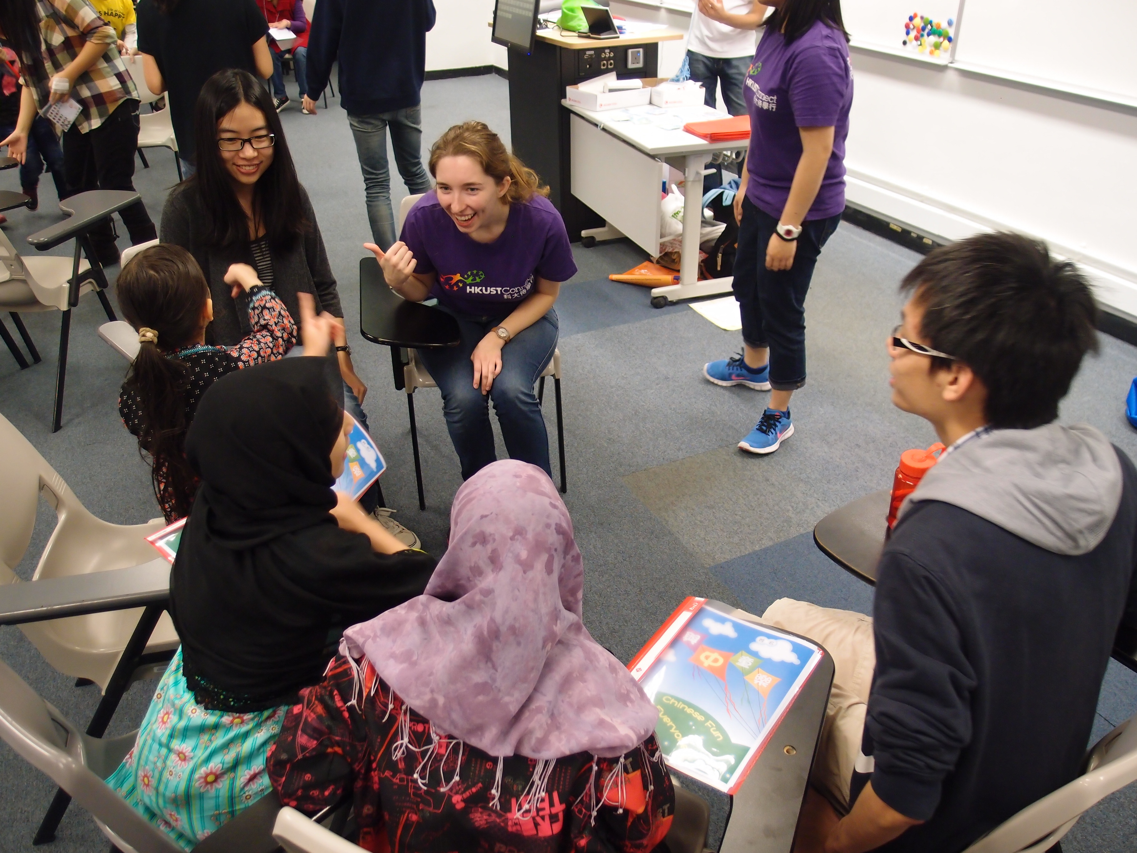Volunteer chatting with children during the break