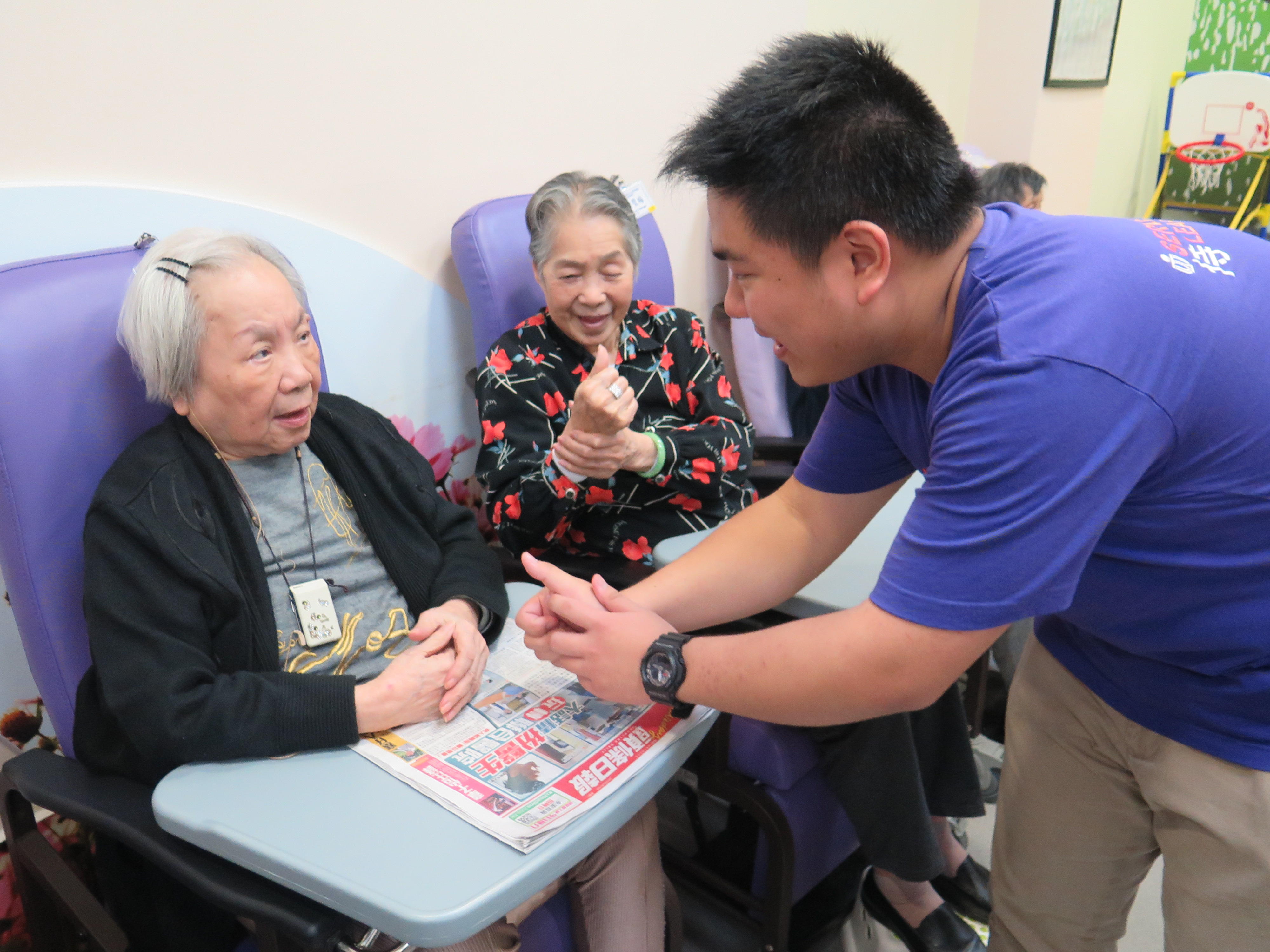 Volunteer chatting with elderly