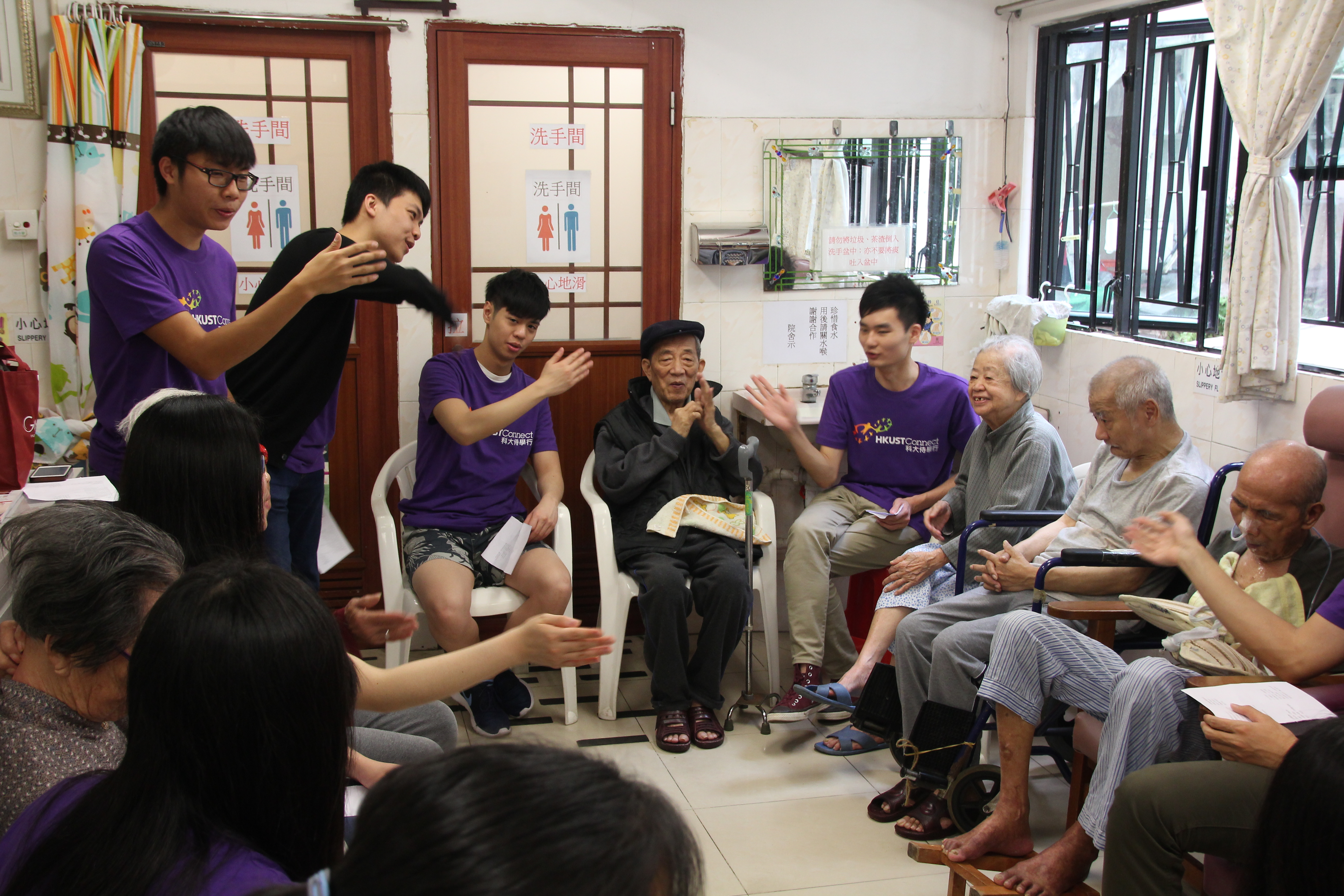 The elderly singing along with the volunteers with hand motions