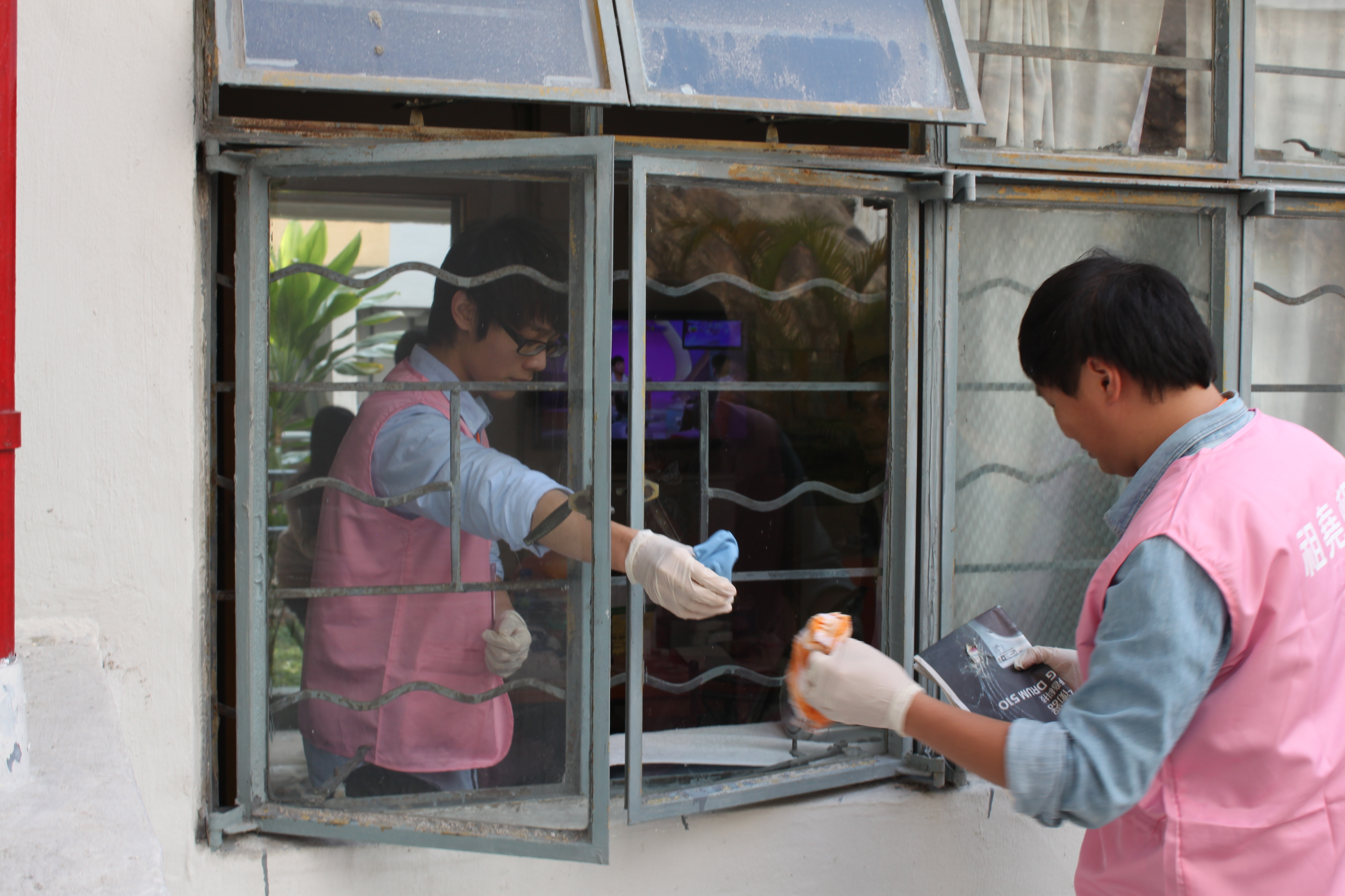 Volunteers cleaning the windows of the service recipients
