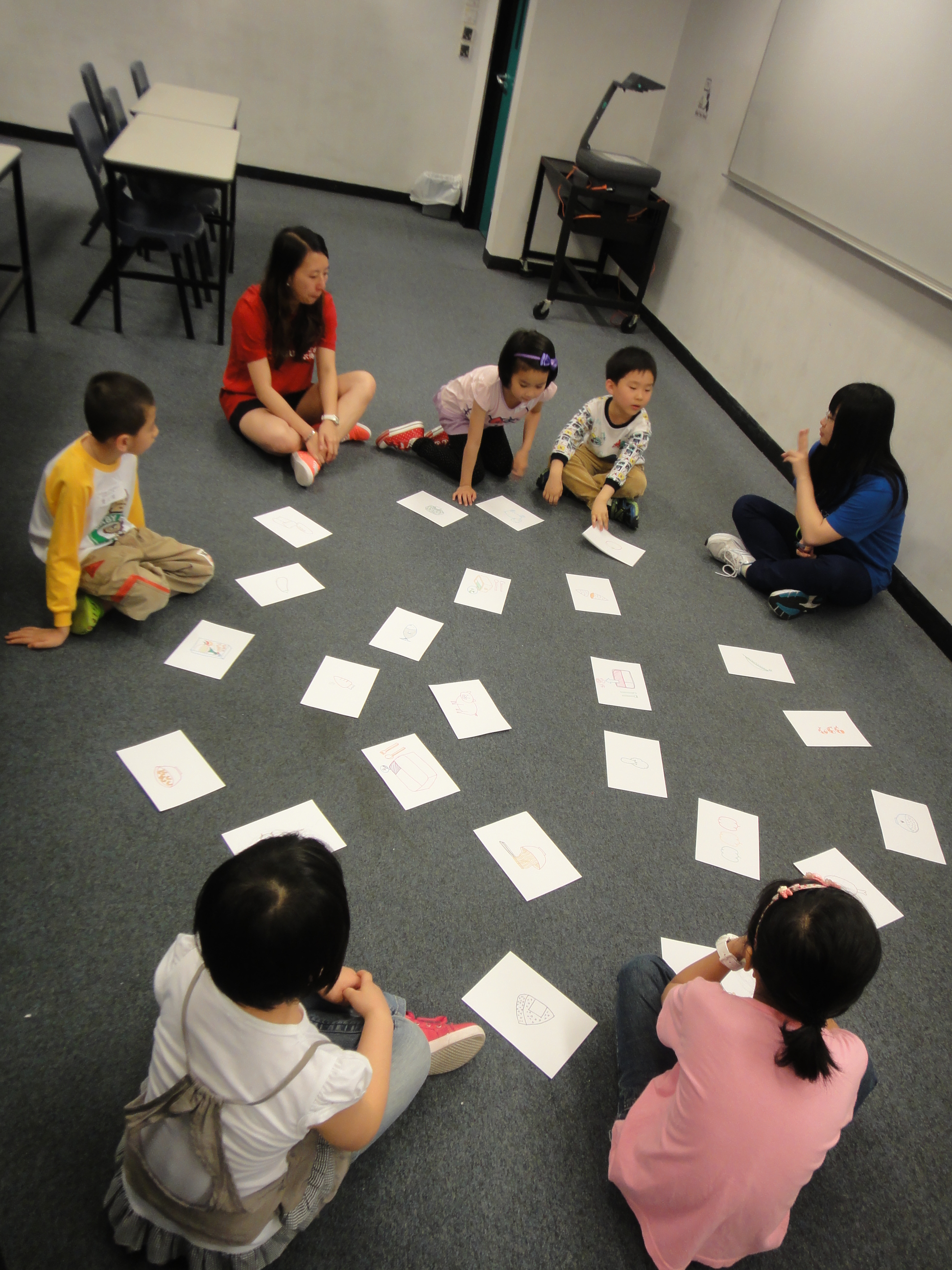 Volunteers playing a card game with the children to ask them identify the healthy food