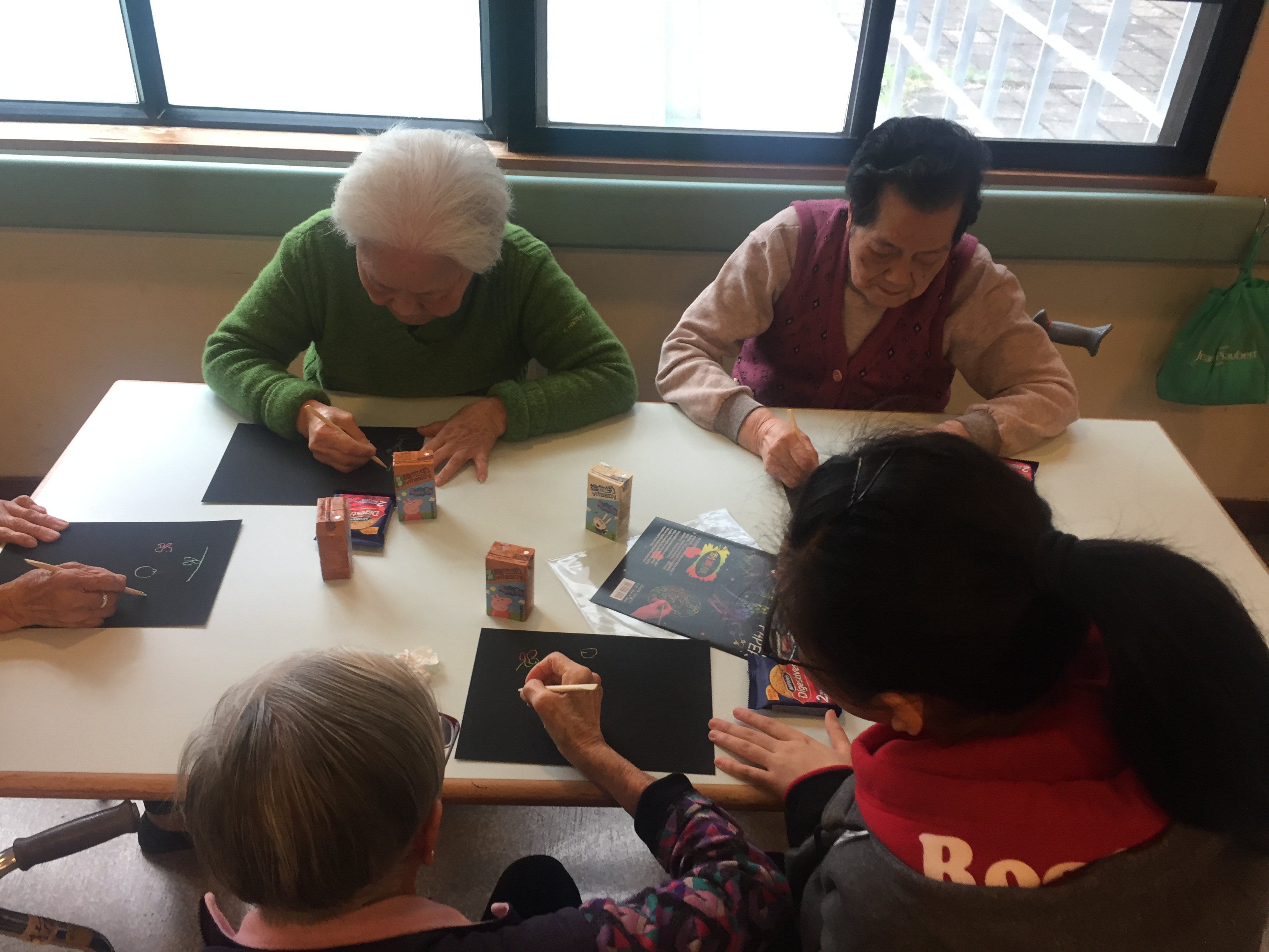 Volunteers doing art crafts with elderly