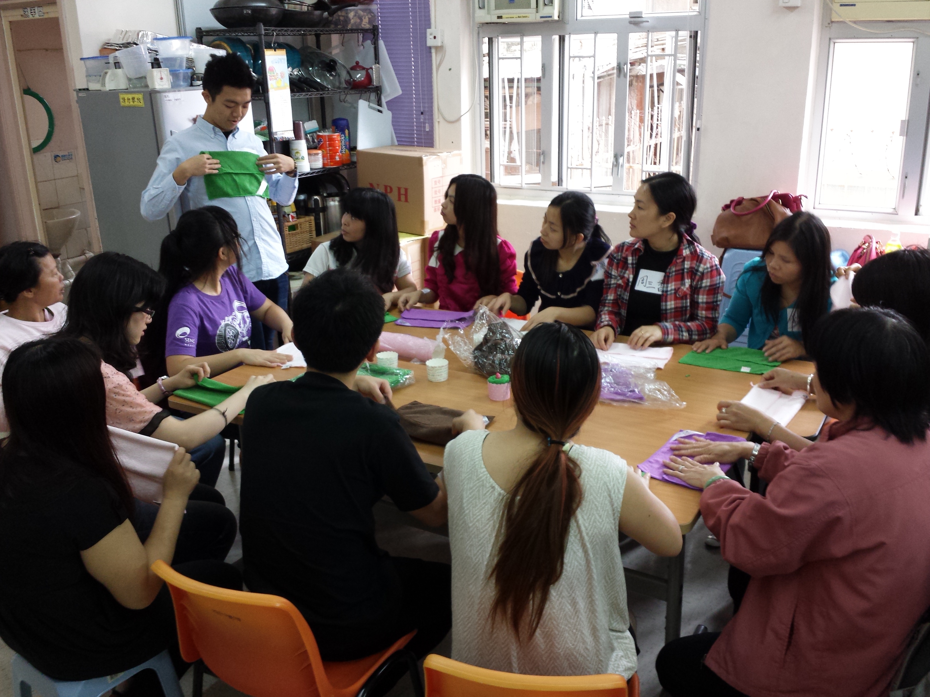 Volunteer explaining how to make a "rabbit"