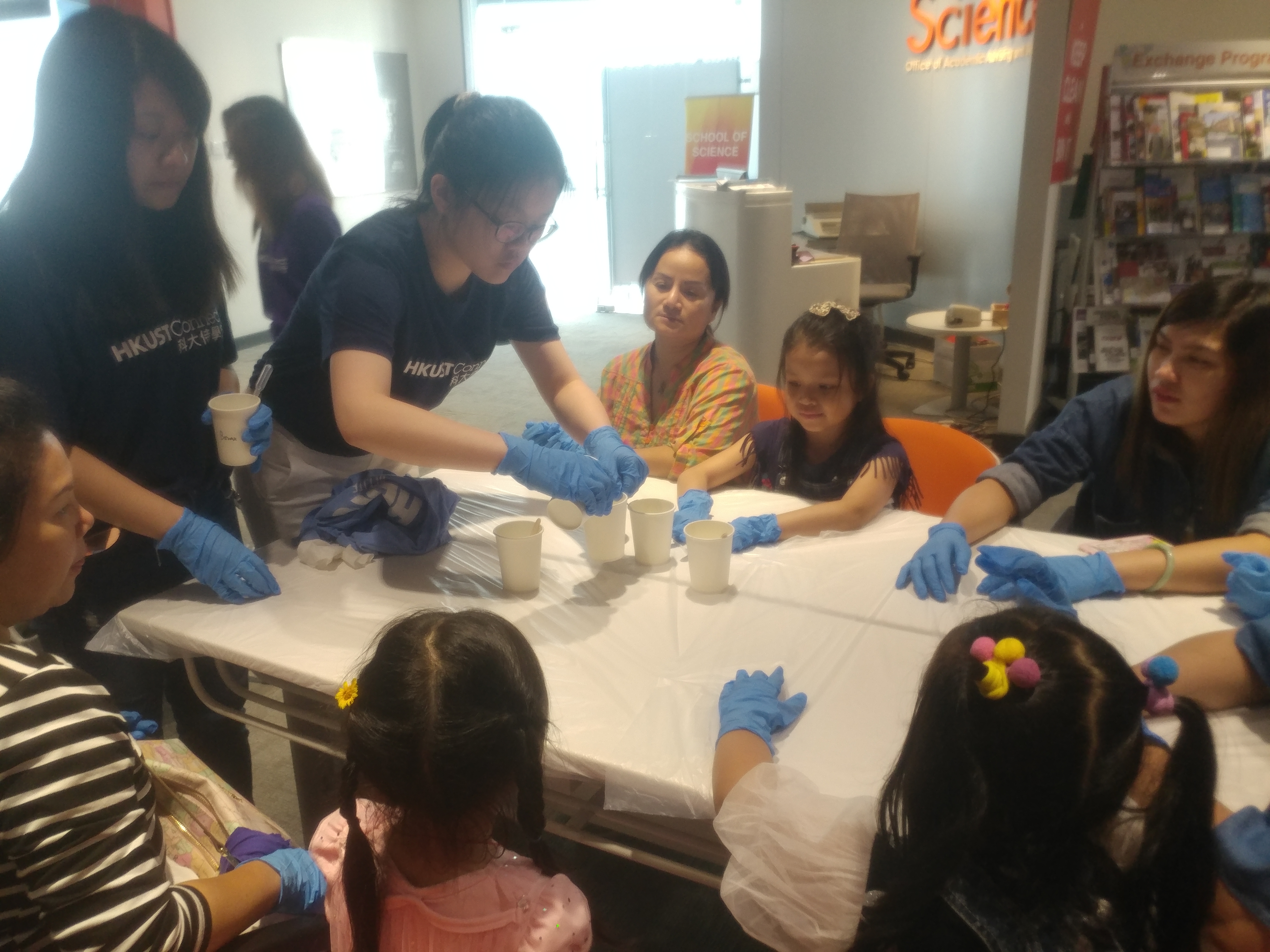 Children and Volunteers start their small chemical experiment.