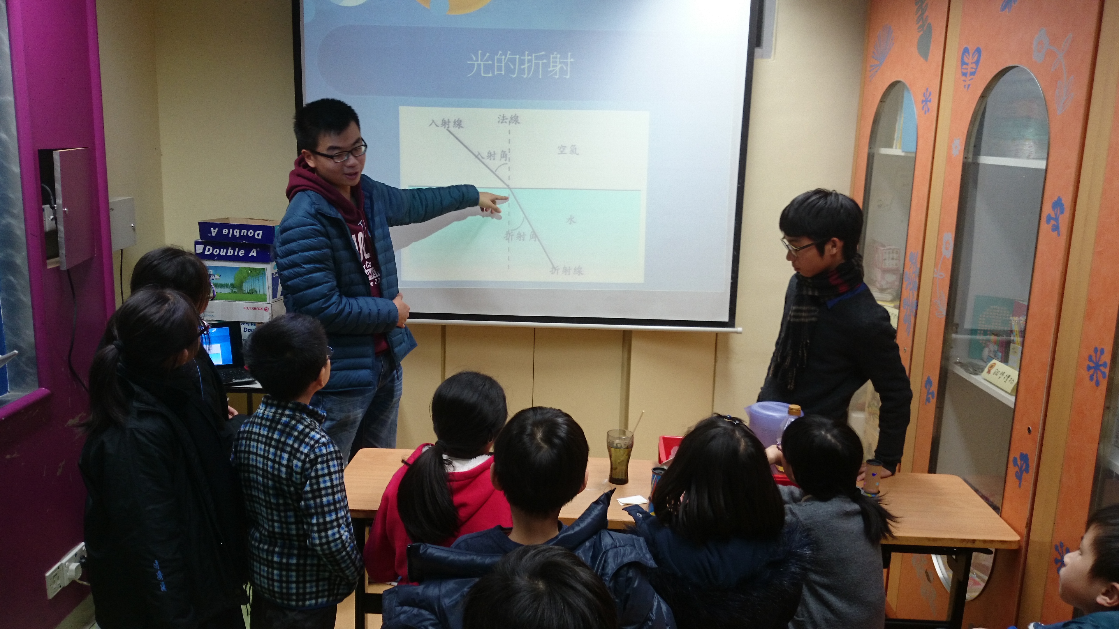 Volunteers explaining "refraction of light"