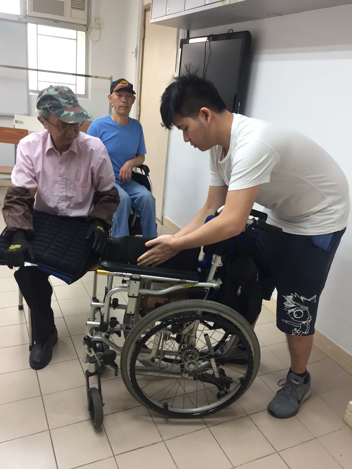 Volunteer learning how to use the wheelchair
