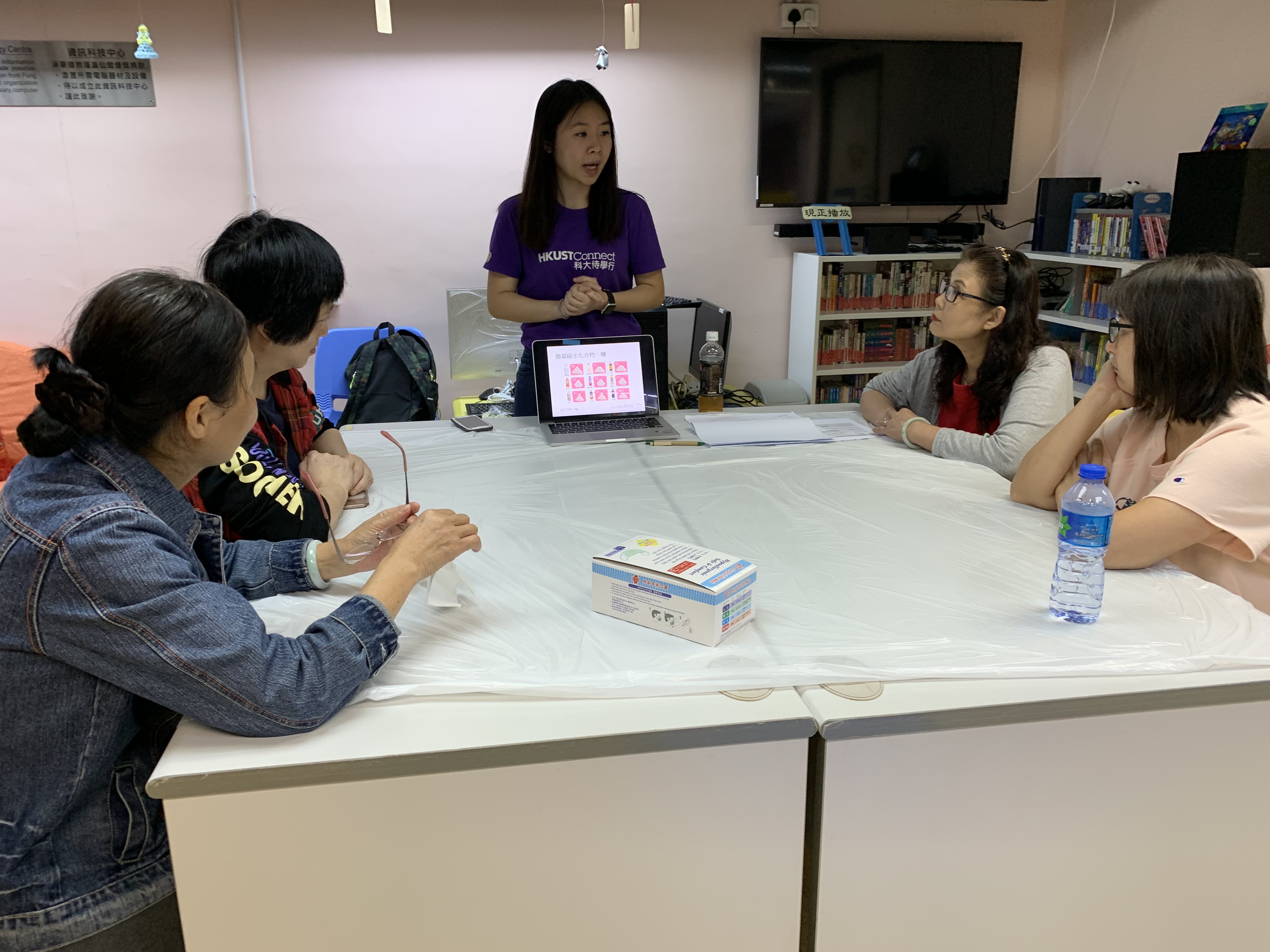 Volunteers teaching parents how to cook healthier