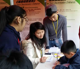 Volunteers hosting a booth game for the service recipients