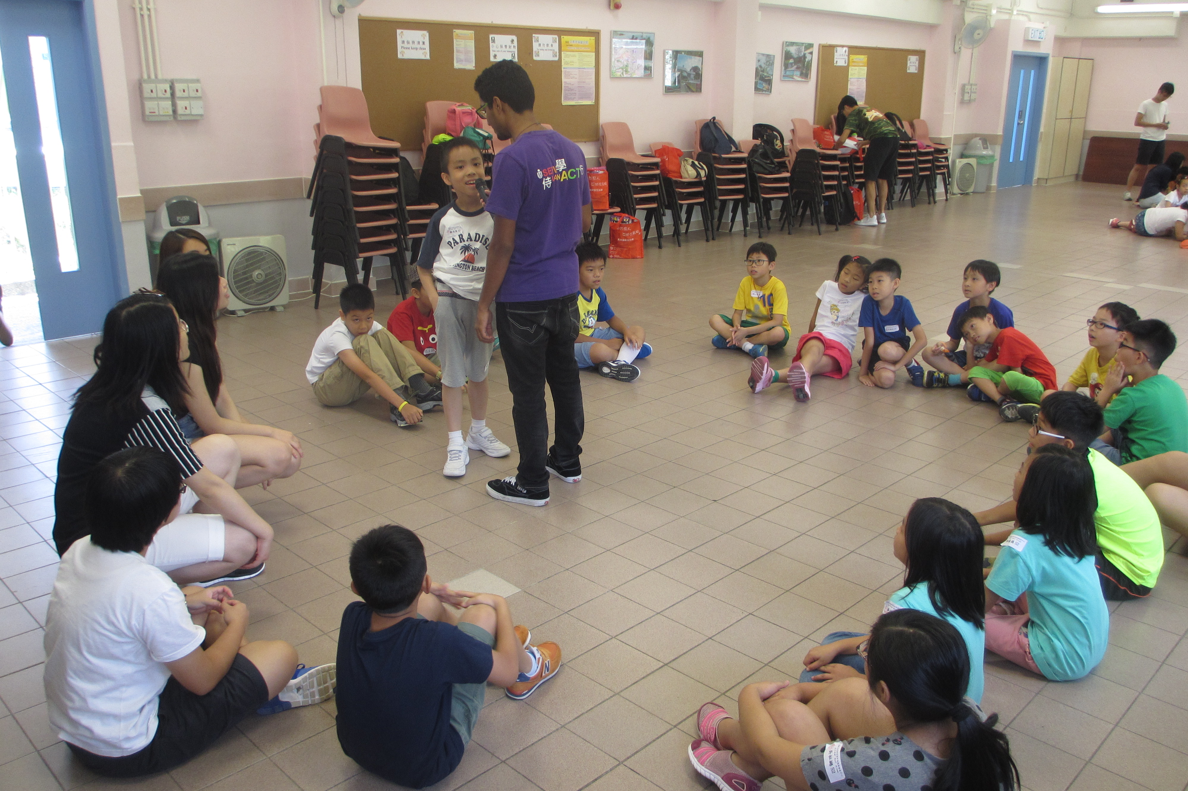 Volunteer inviting a child for sharing