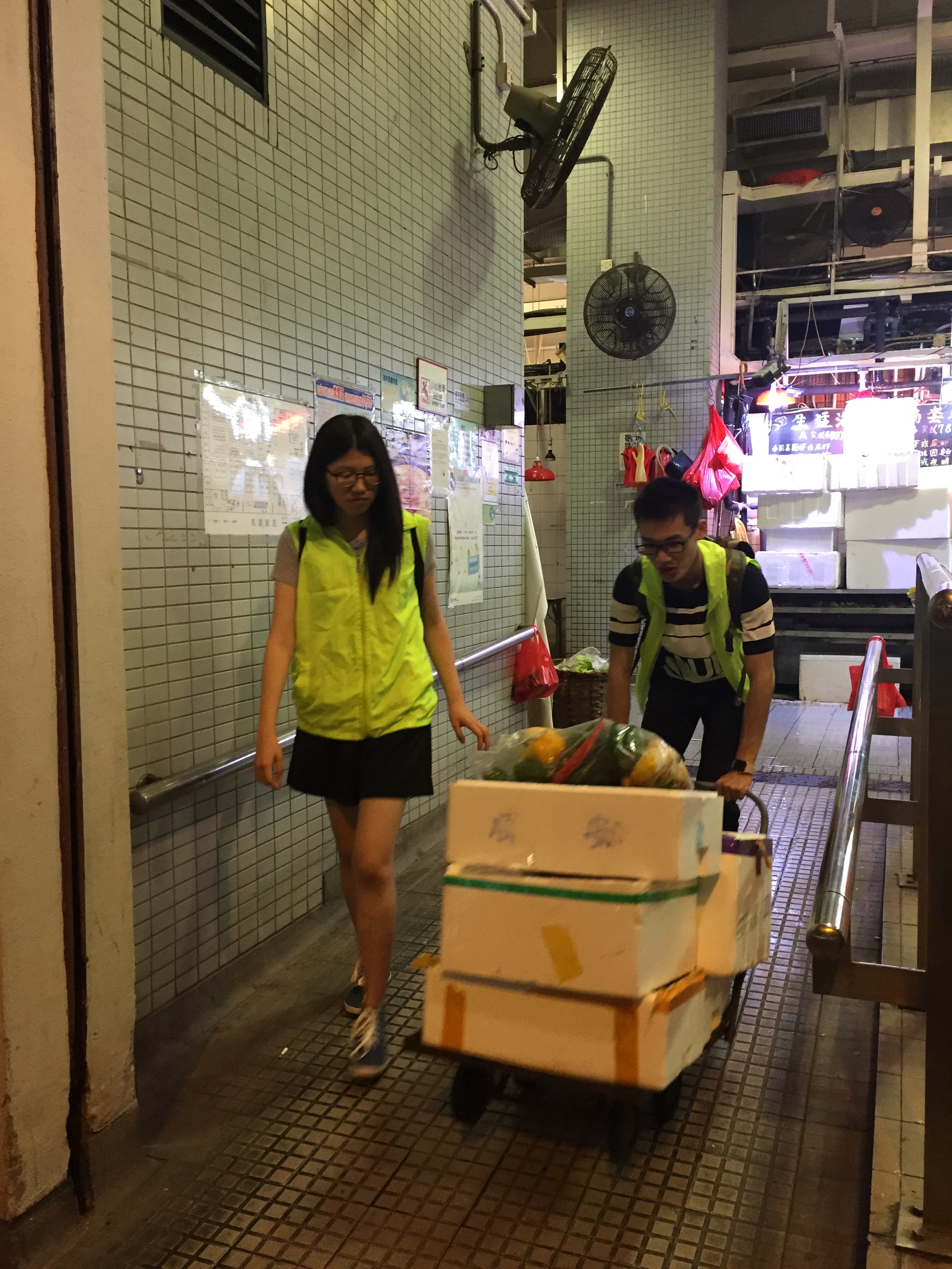 Volunteers transporting the unsold food to nearby needy elderly.