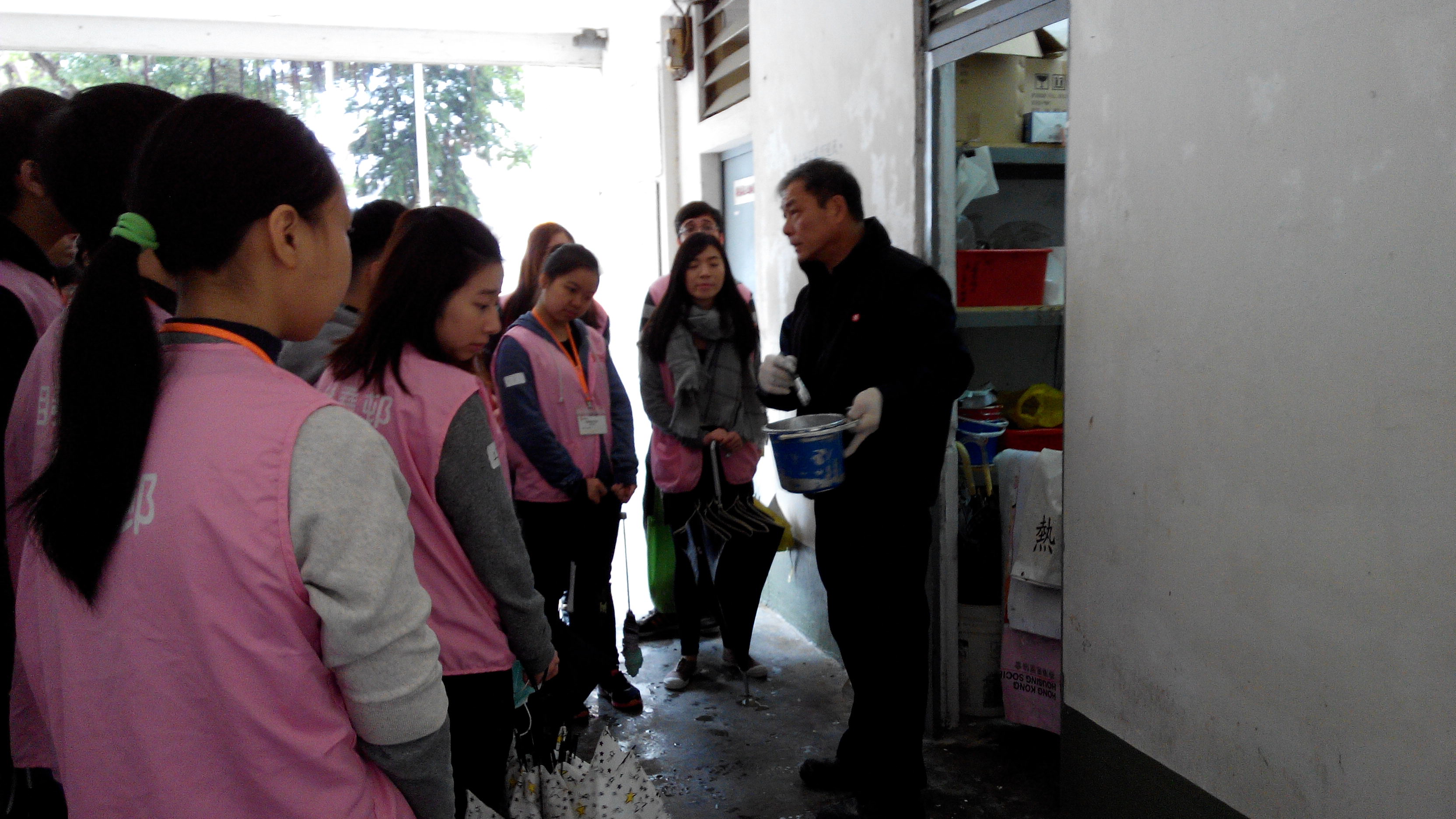 Volunteers preparing for the gate-painting service during a paint demonstration