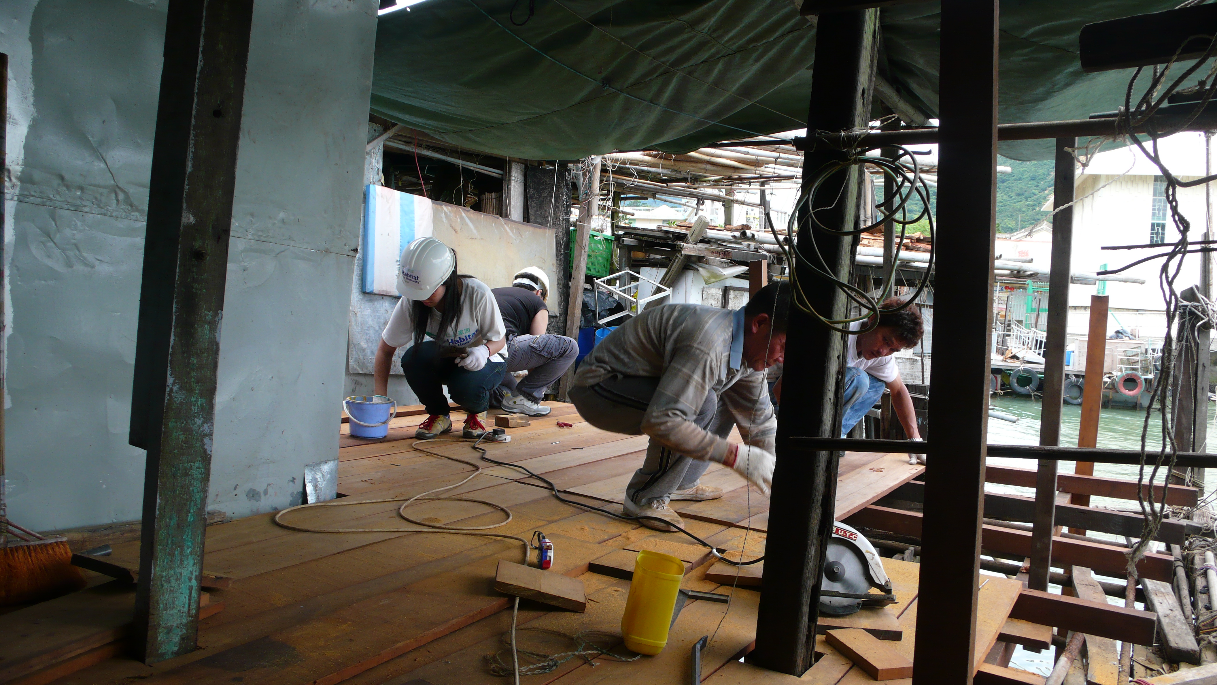 Students working with local workers to restore the floor.