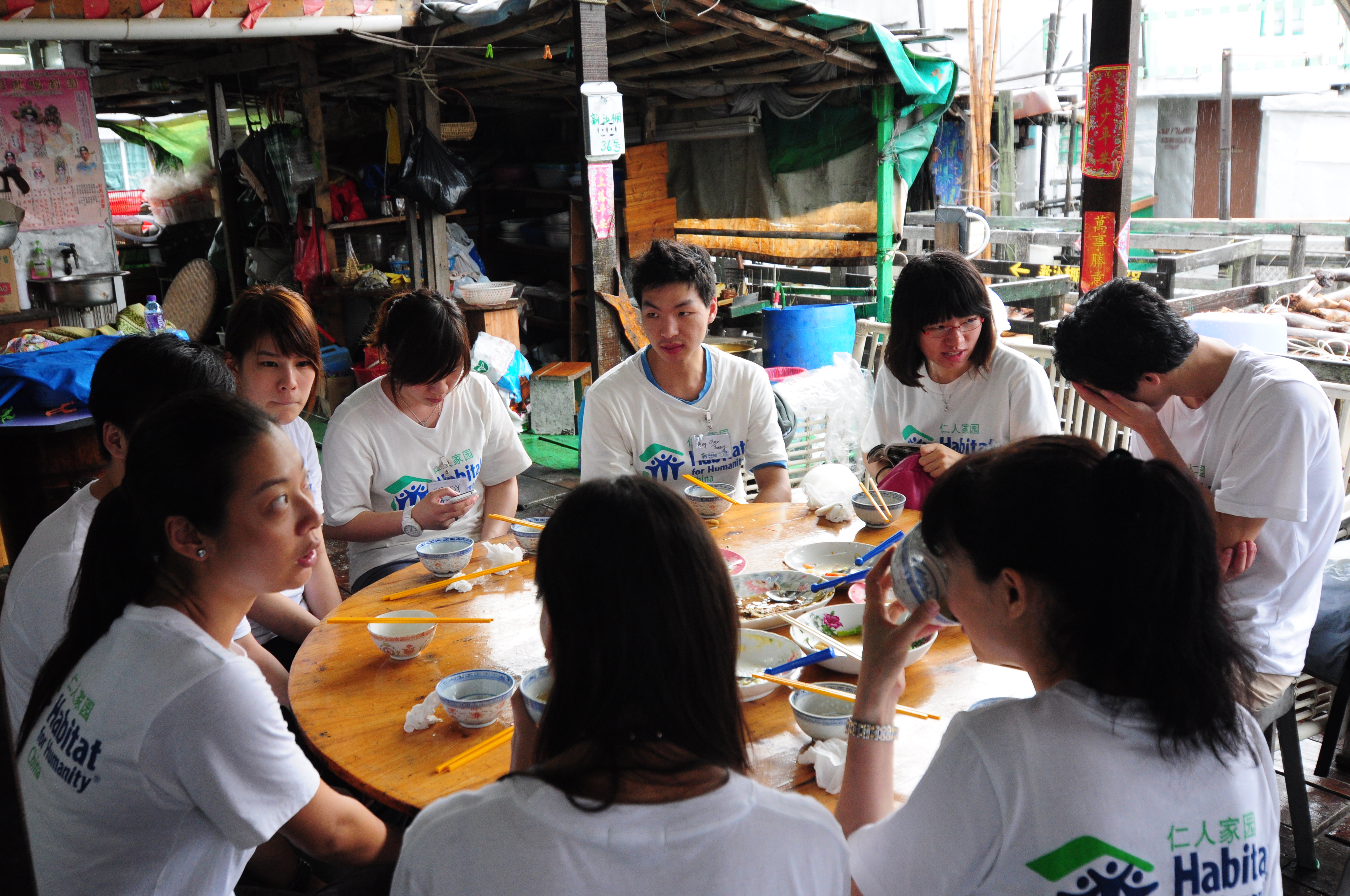 Students tasting local Tai O food during lunch.