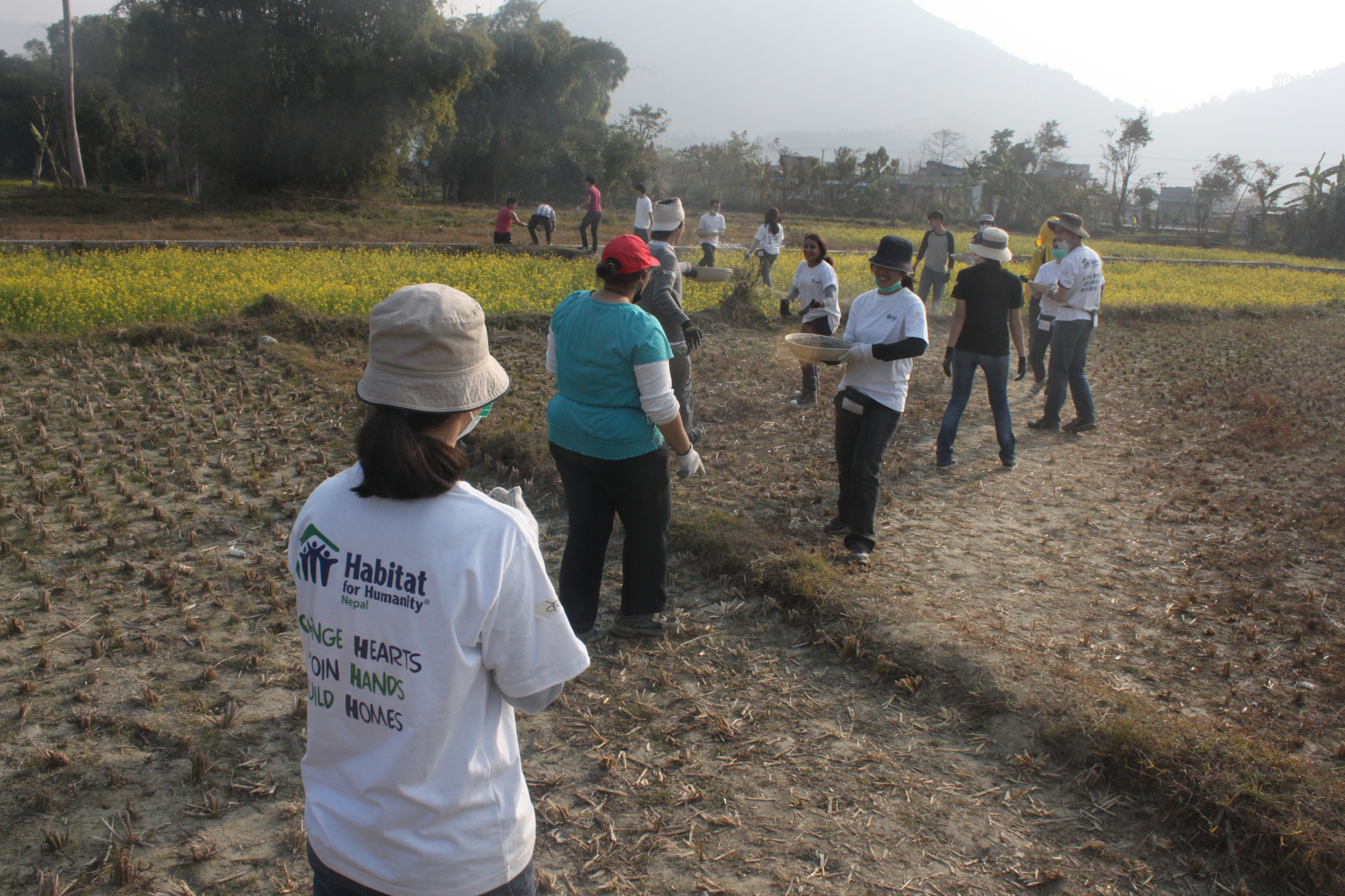 Forming a human chain to pass building materials