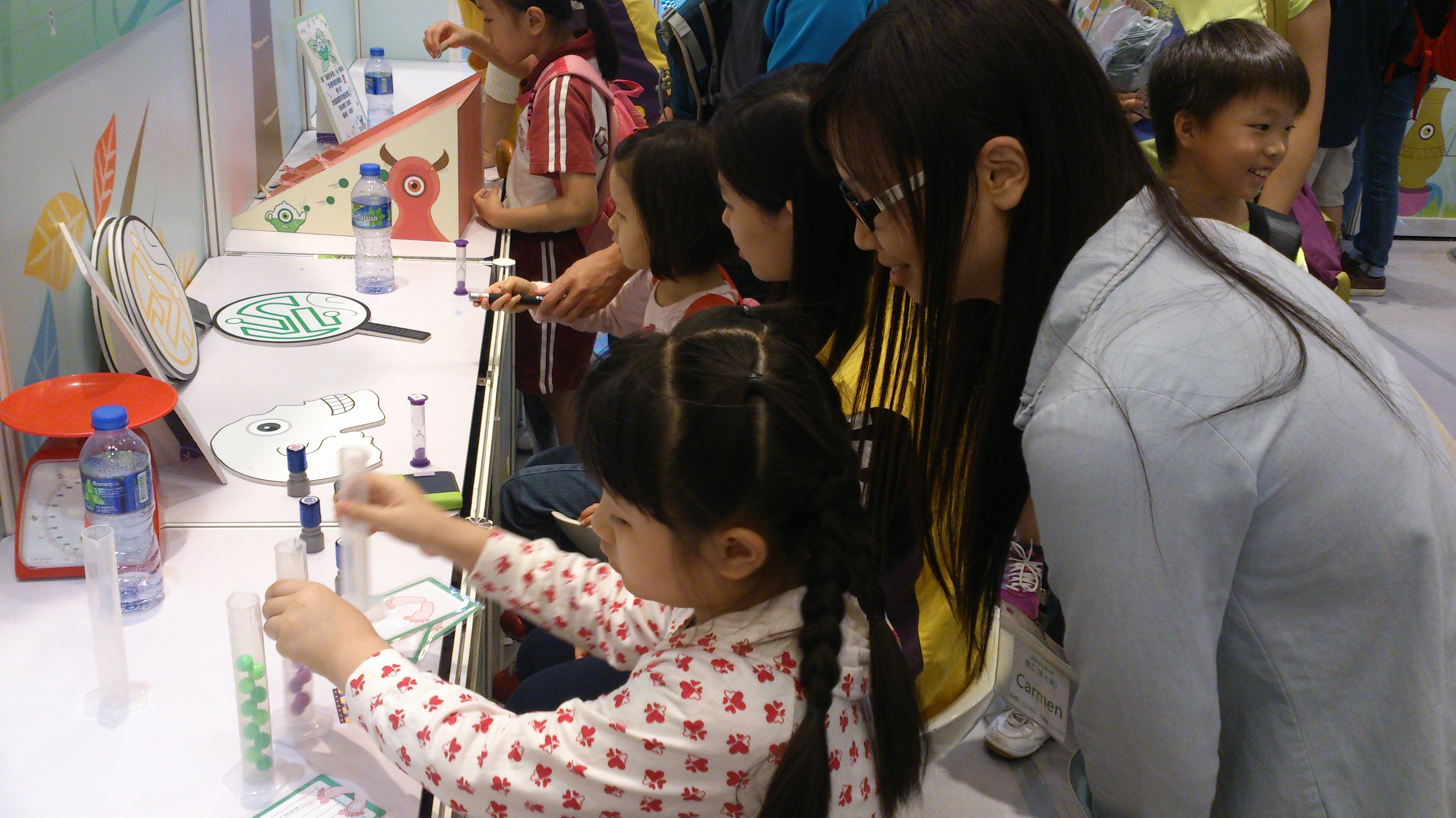 Volunteers playing in the booth with the kids