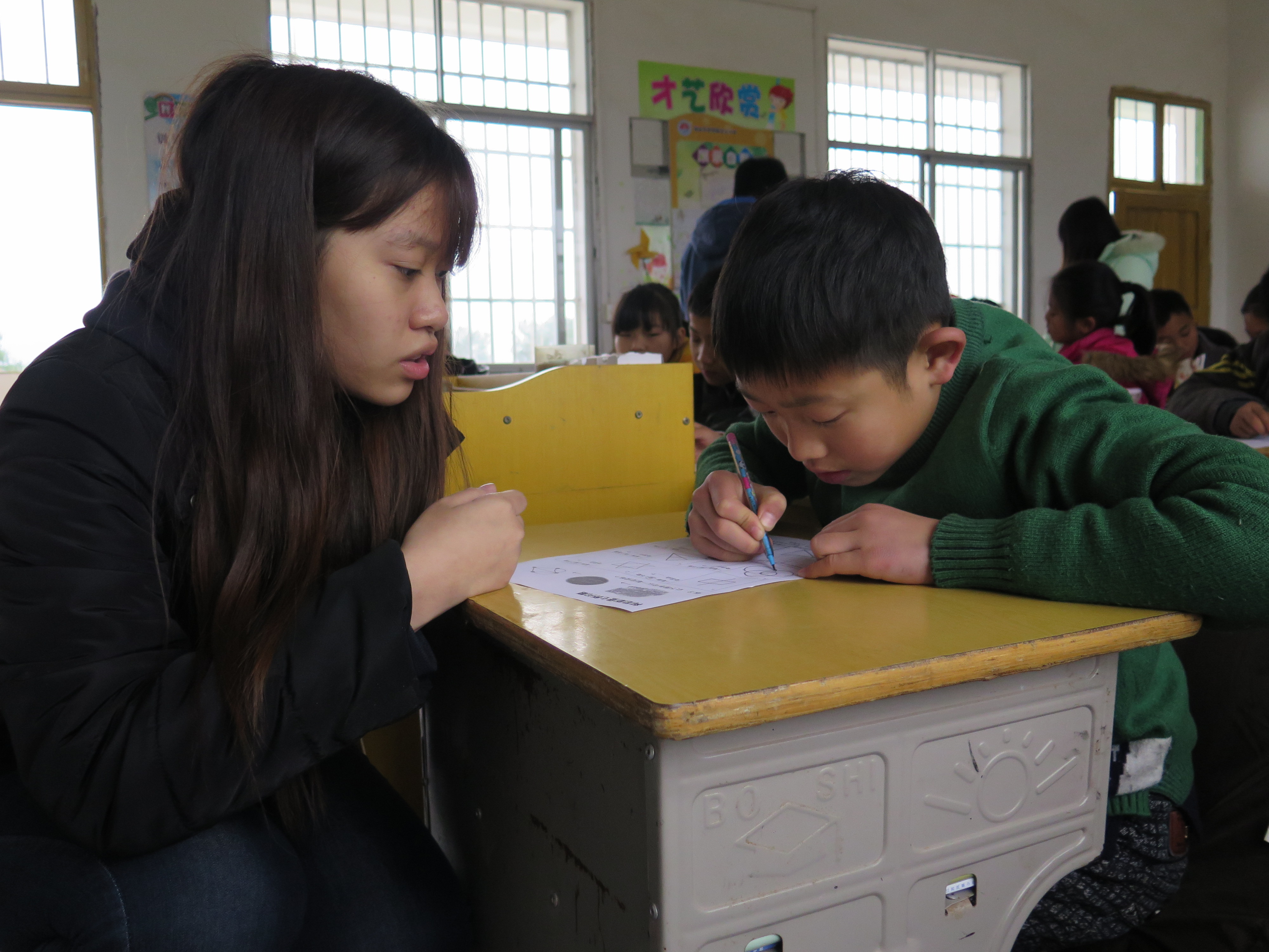 Volunteers doing Math homework with the children