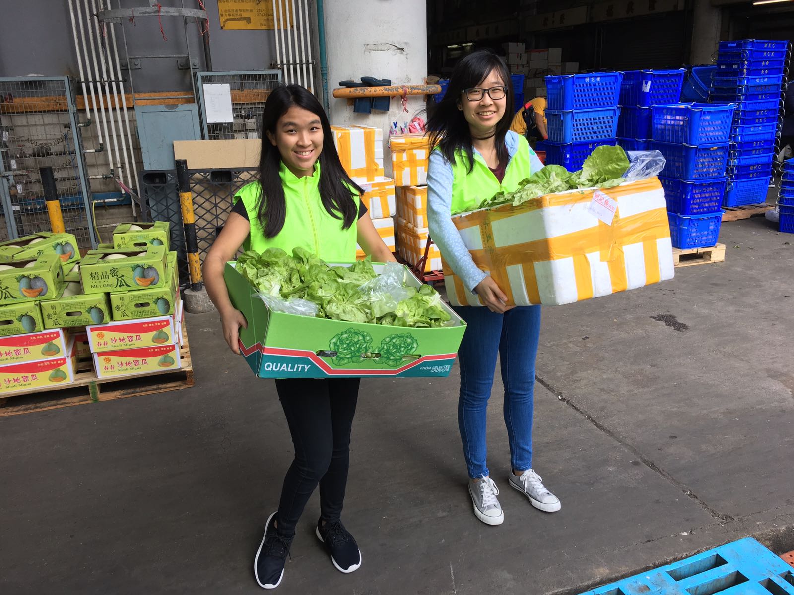Volunteers transporting the edible unsold vegetables to the booth for fund raisin