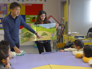 Volunteers serving as reading buddies for children