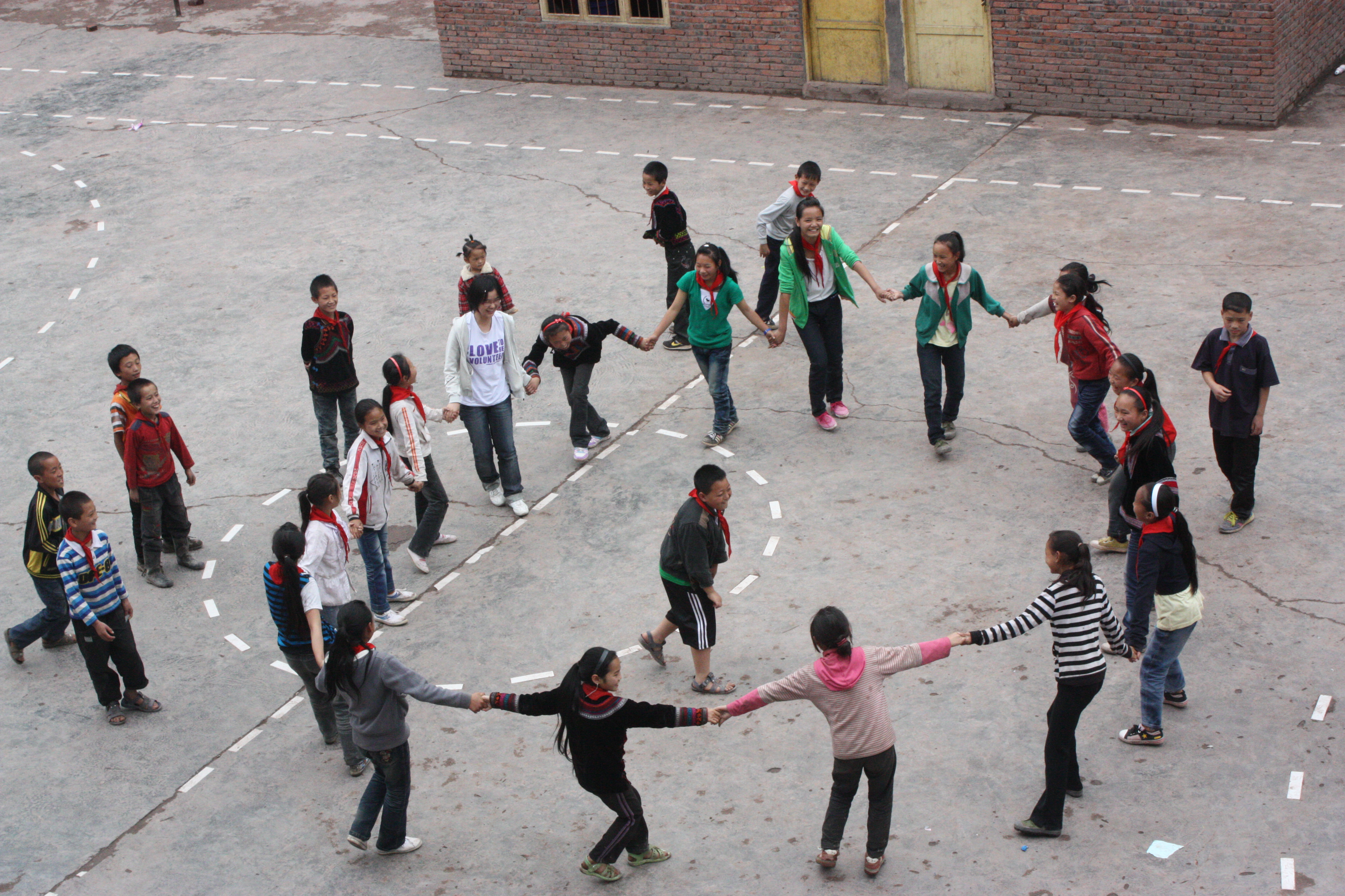 Our students and the local children playing games happily