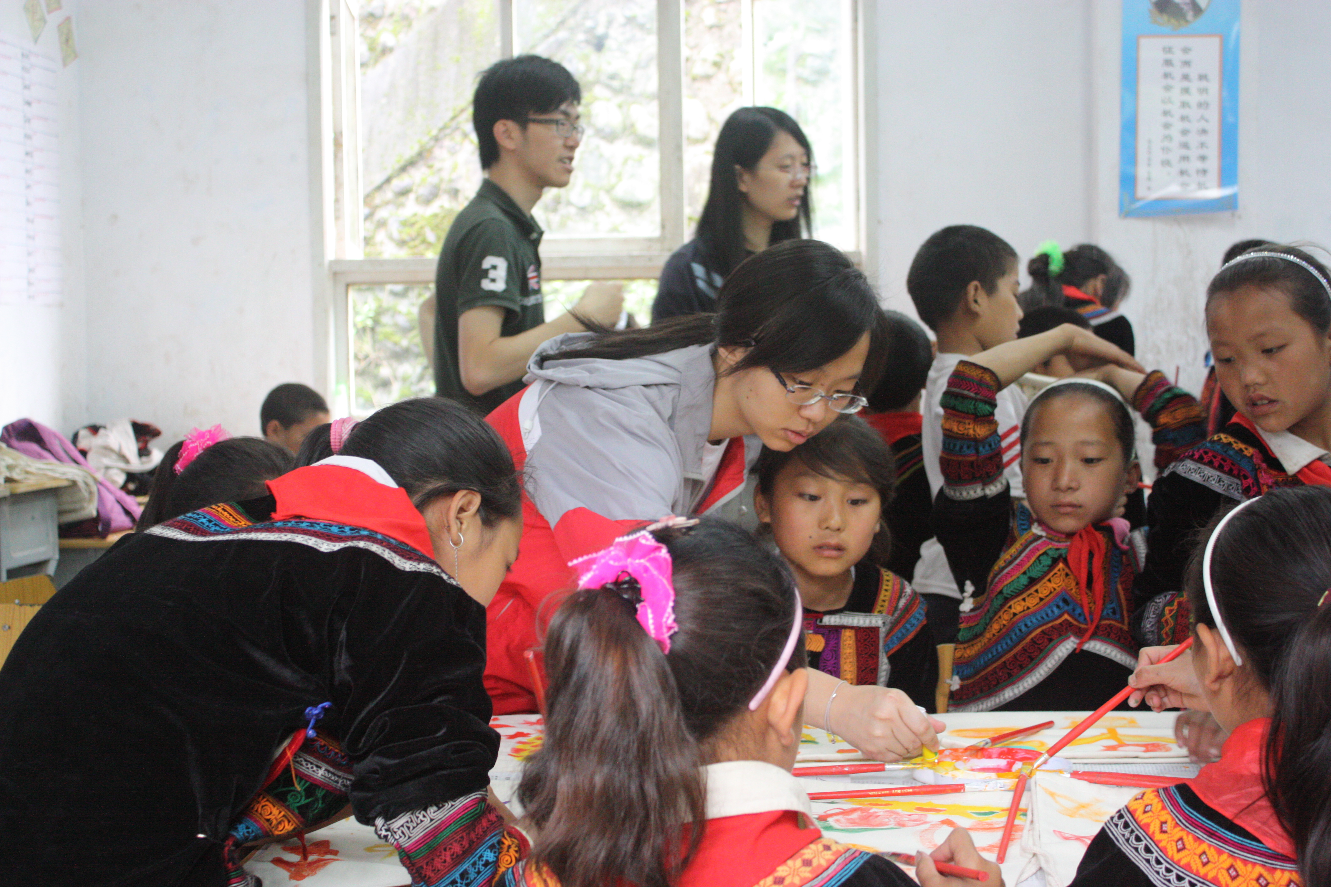 Volunteers helping children to design their own bags