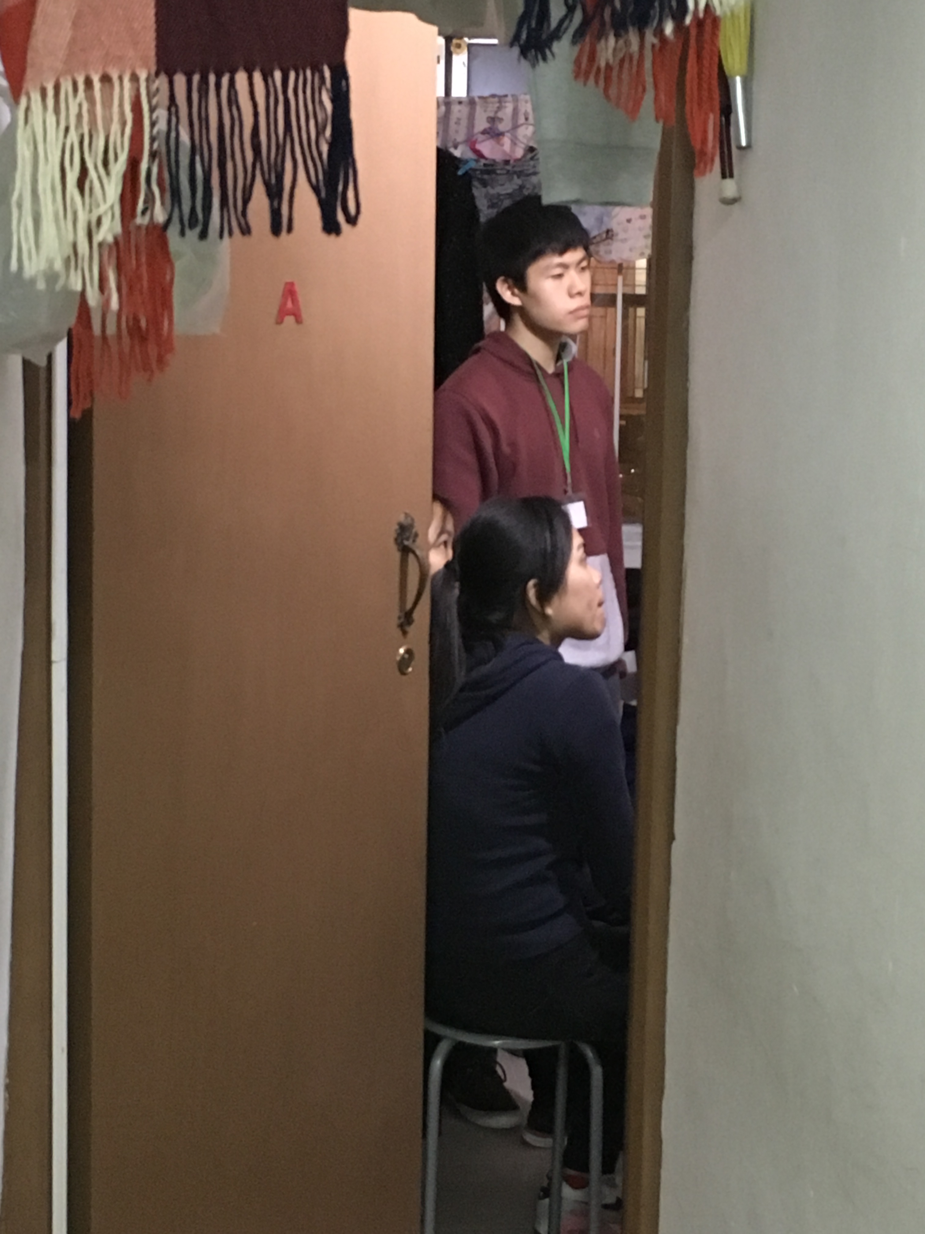Volunteers visiting a family living in a subdivided housing unit