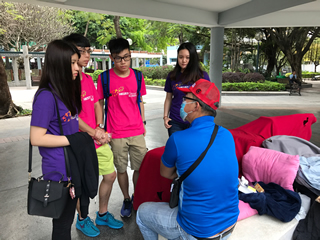 Volunteers chatting with the street sleeper