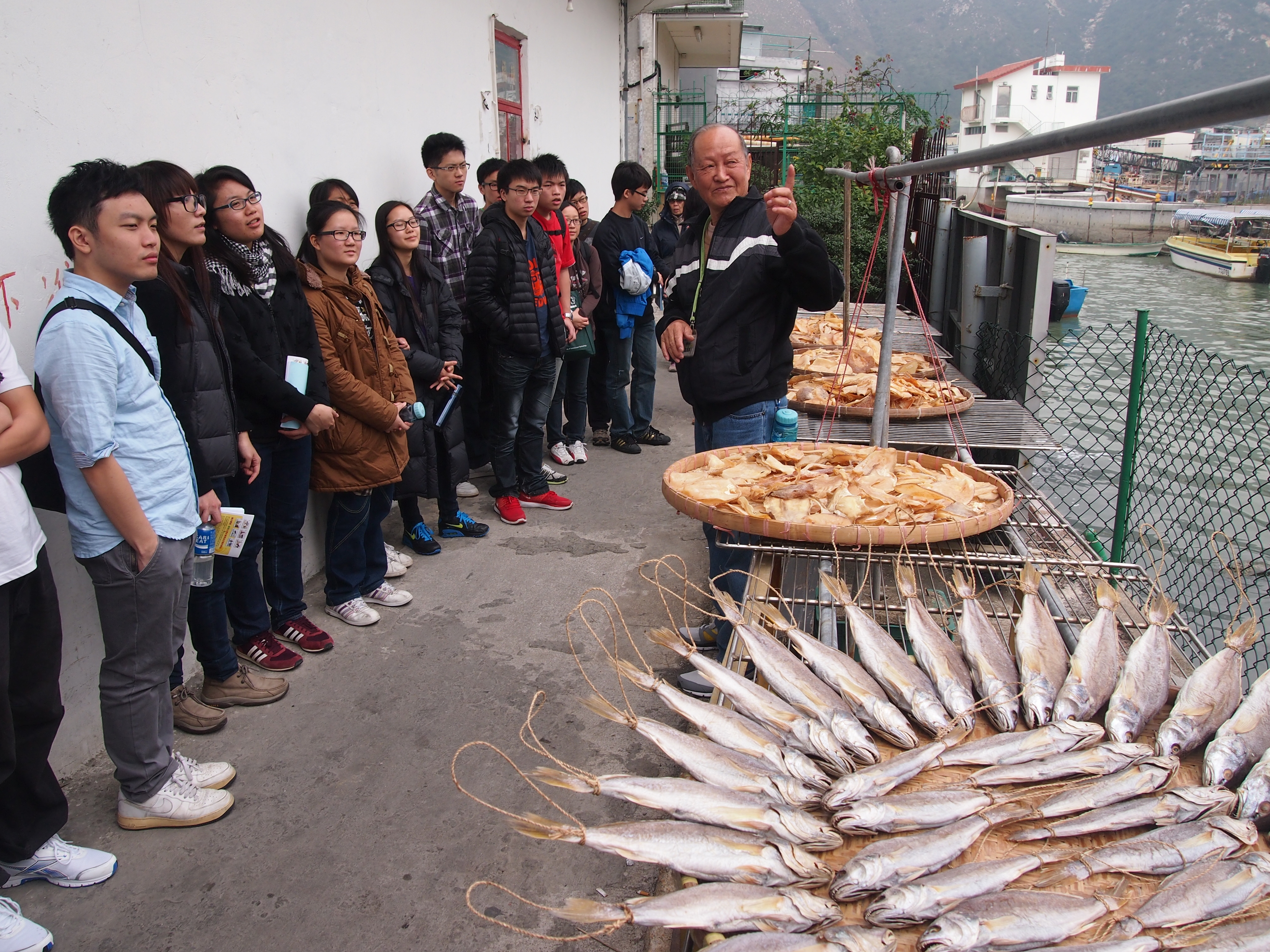 Uncle Wing, a local Tai O resident, telling volunteers about the history of the community