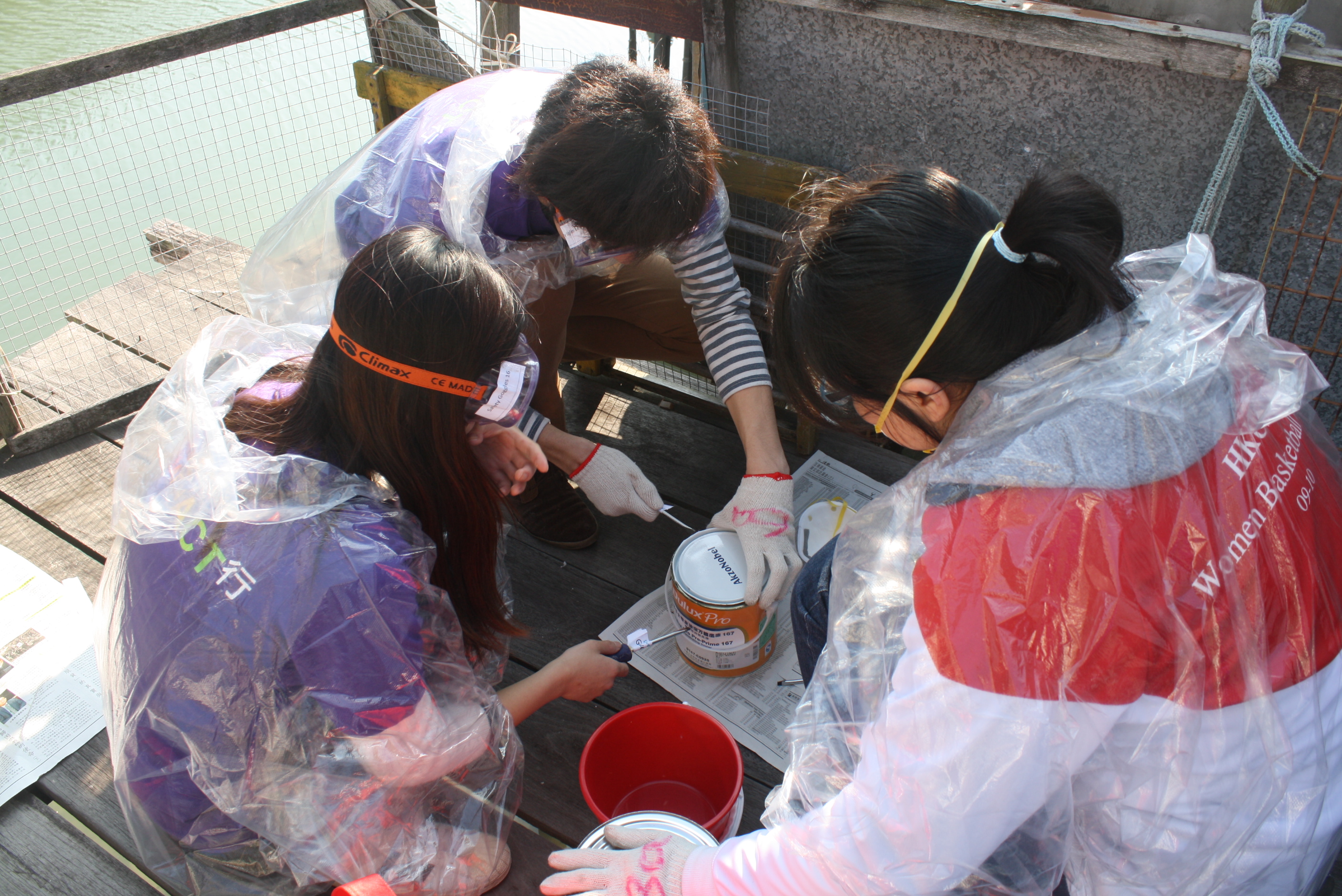 Volunteers preparing the paint for refurbishment