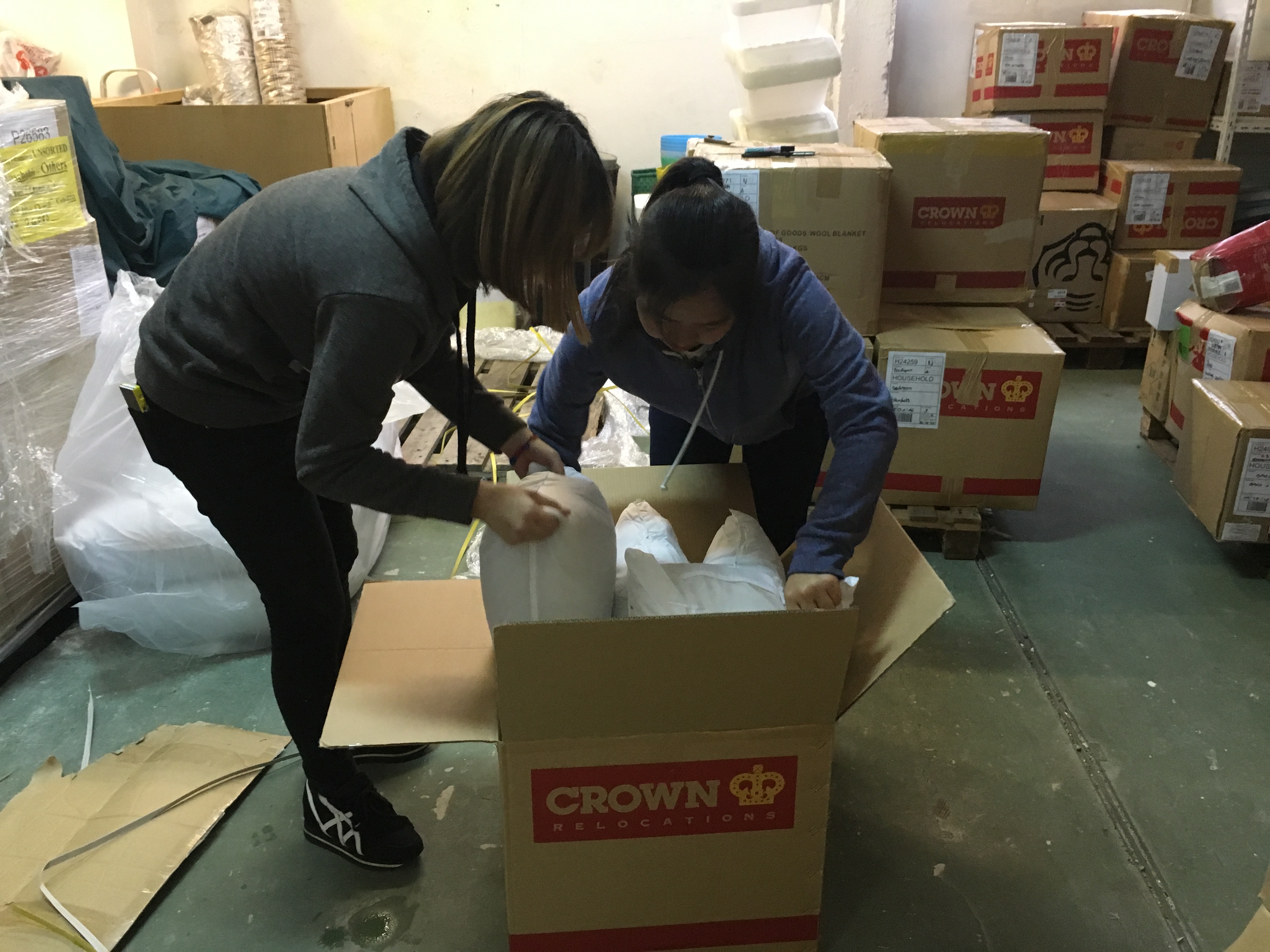 Volunteers repacking the donated dormitory ultilities.