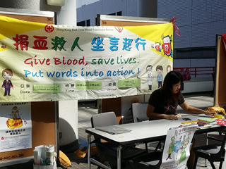 Volunteers setting up the promotion counter at the atrium