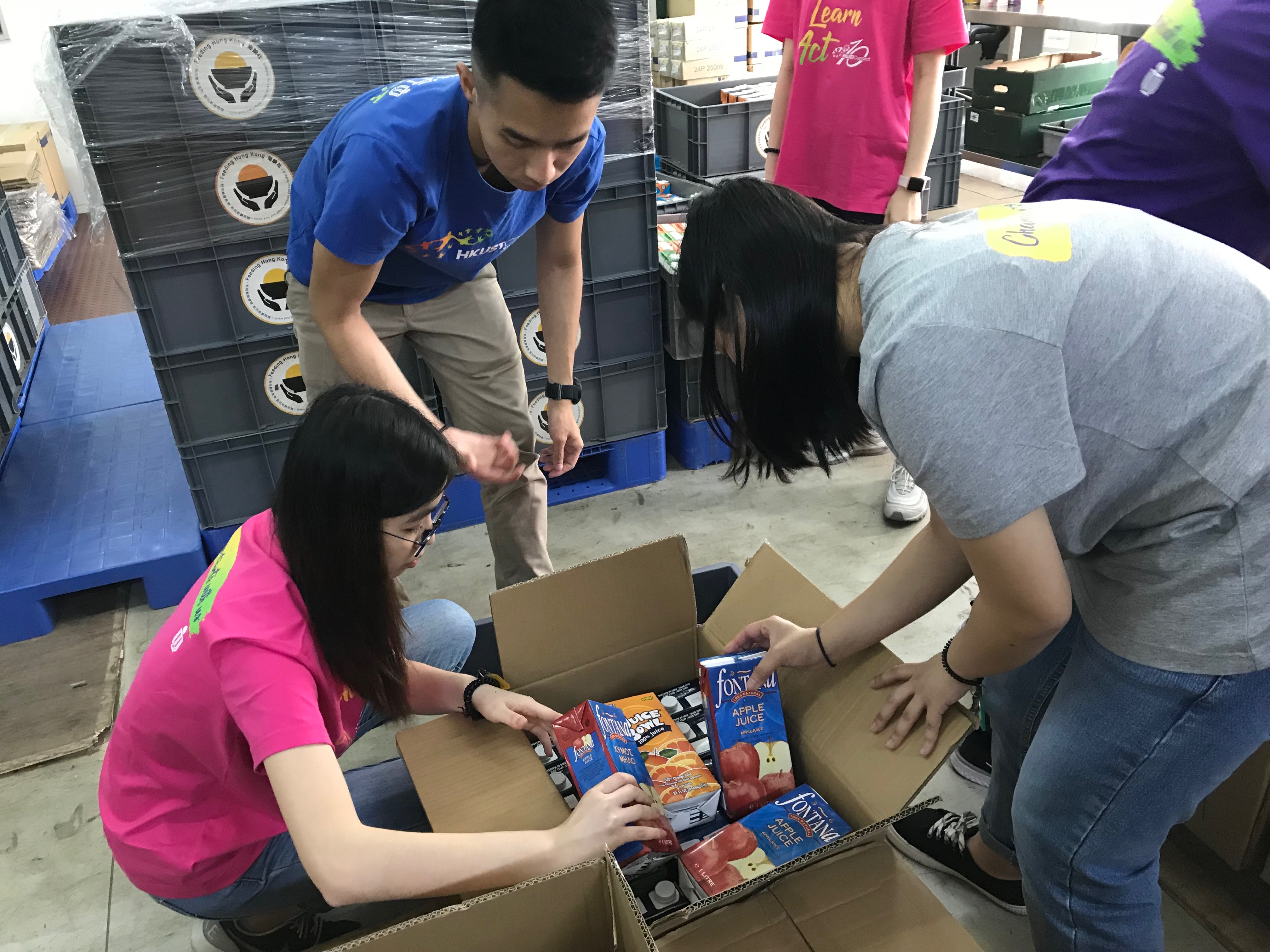 Volunteers sorting and packing food donation