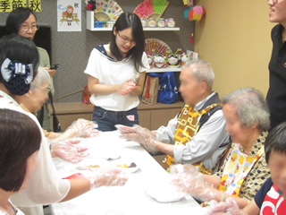 Elders making rice balls together with their family