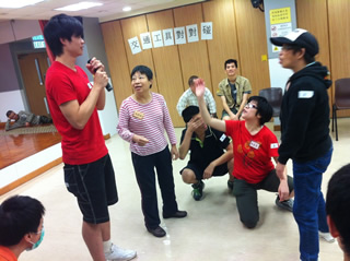 A student volunteer giving instruction to participants