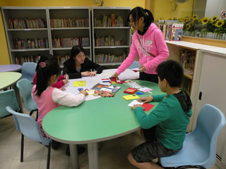 Volunteers facilitating in a handicraft making session