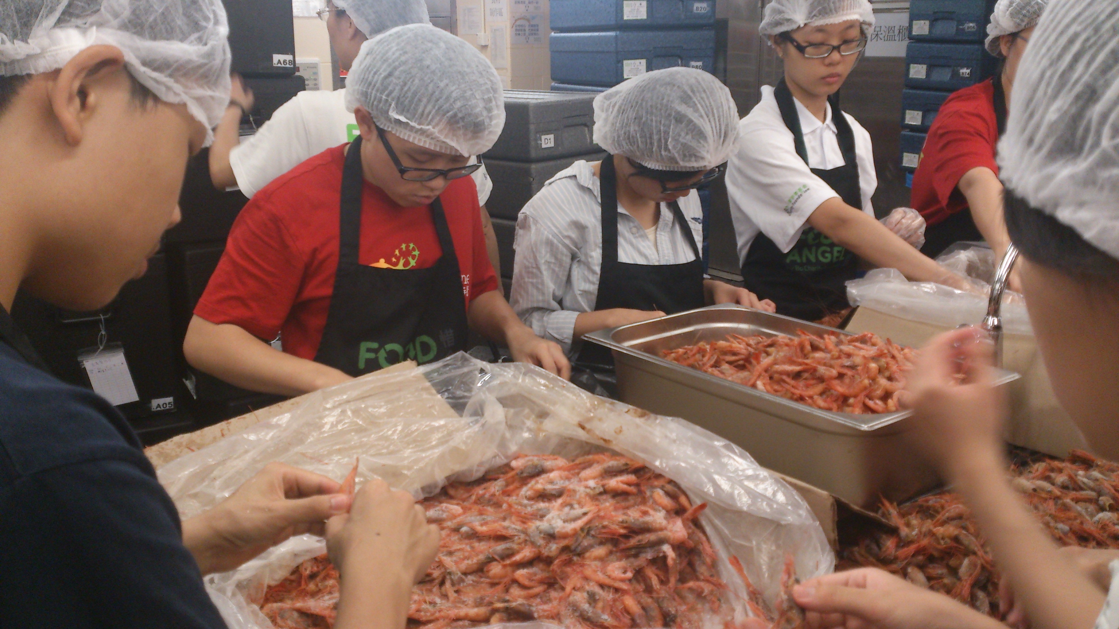 Our students preparing the shrimp for the meal box