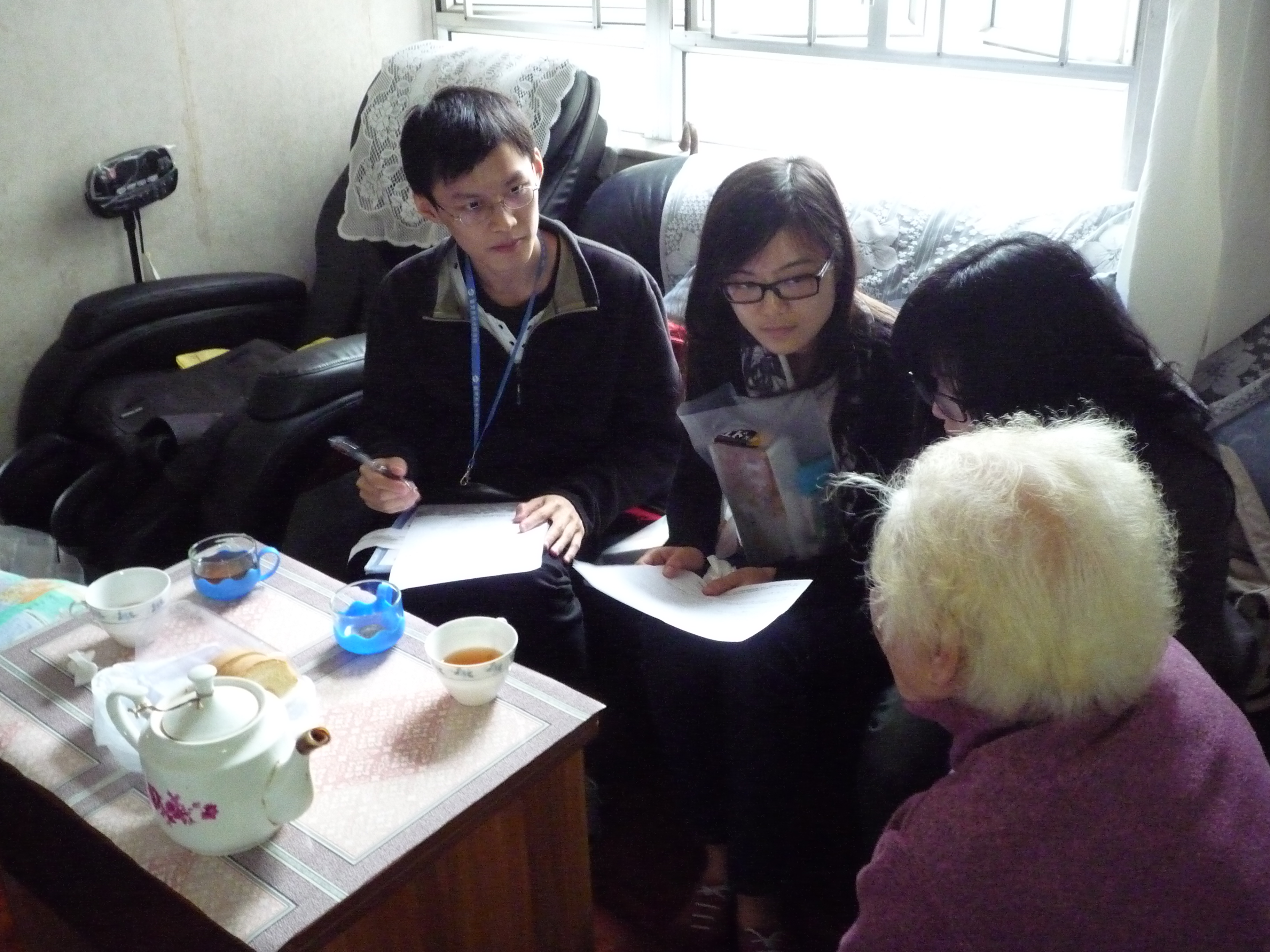 Our students visiting the elder and noting down her needs